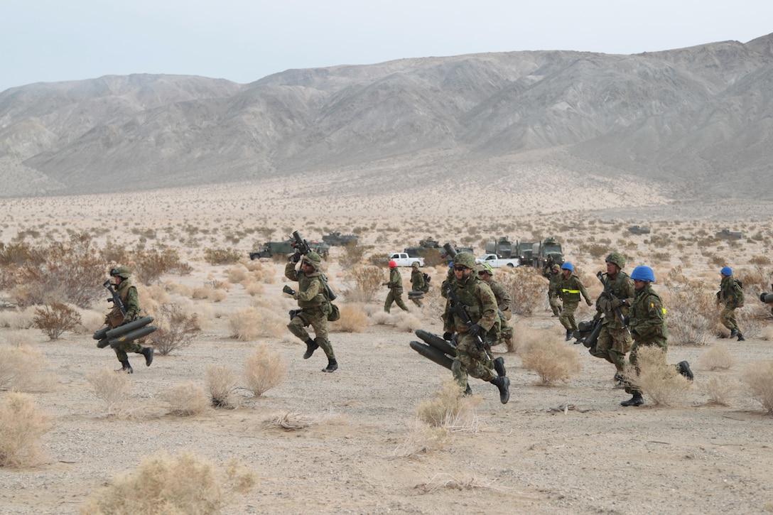 Members of the Japanese ground self-defense forces move toward their objective point as part of movement-to-contact training at Marine Corps Air Ground Combat Center, Twentynine Palms, Calif., Jan 31, 2013.