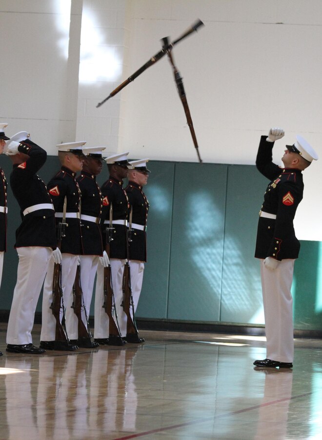 RALEIGH — Cpl. Ryan McKinley, a rifle inspector with the Marine Corps Silent Drill Platoon, catches an M-1 Garand rifle during the platoon’s performance at Ravenscroft School in Raleigh, N.C., Oct. 24, 2012. To show their appreciation for the military Ravenscroft School asked the Silent Drill Platoon to perform. 