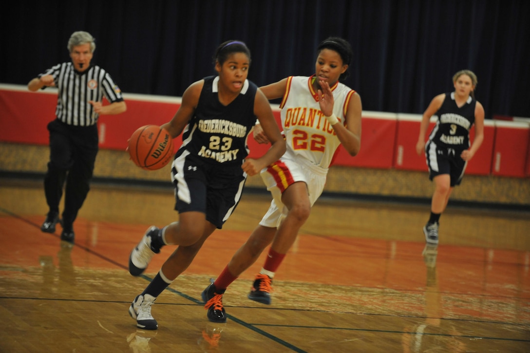 Brittany, Quantico Middle/High School Lady Warriors Varsity Basketball Team player, struggles to cover an opponent in the open court during a Delaney Athletic Conference game against the Fredericksburg Academy Falcons at Quantico on Jan. 30. The Falcons made a stand in the second half that brought them the game win, 37-18.