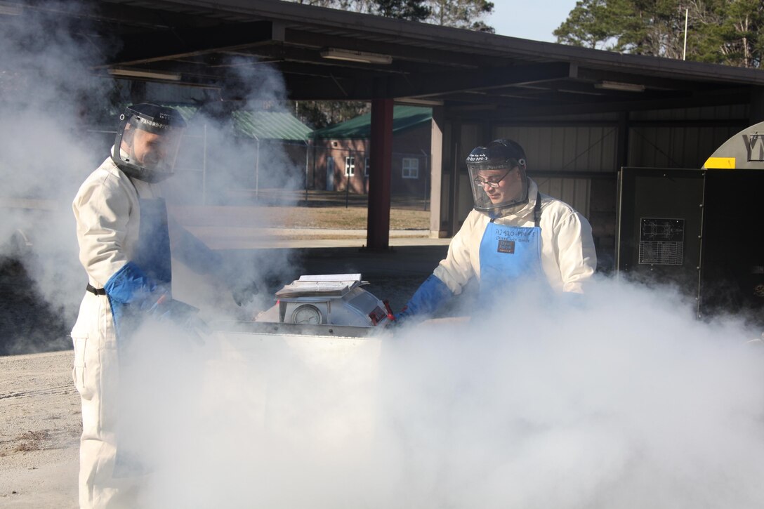 Smoke from the liquid oxygen surround Lance Cpl. Daniel Hernandez, right, and Lance Cpl. Alexander Guajardo, as they work on filling a 50-gallon tank outside the cryogenics compound at Cherry Point Jan. 22. Both are cryogenic technicians with Marine Aviation Logistics Squadron 14.