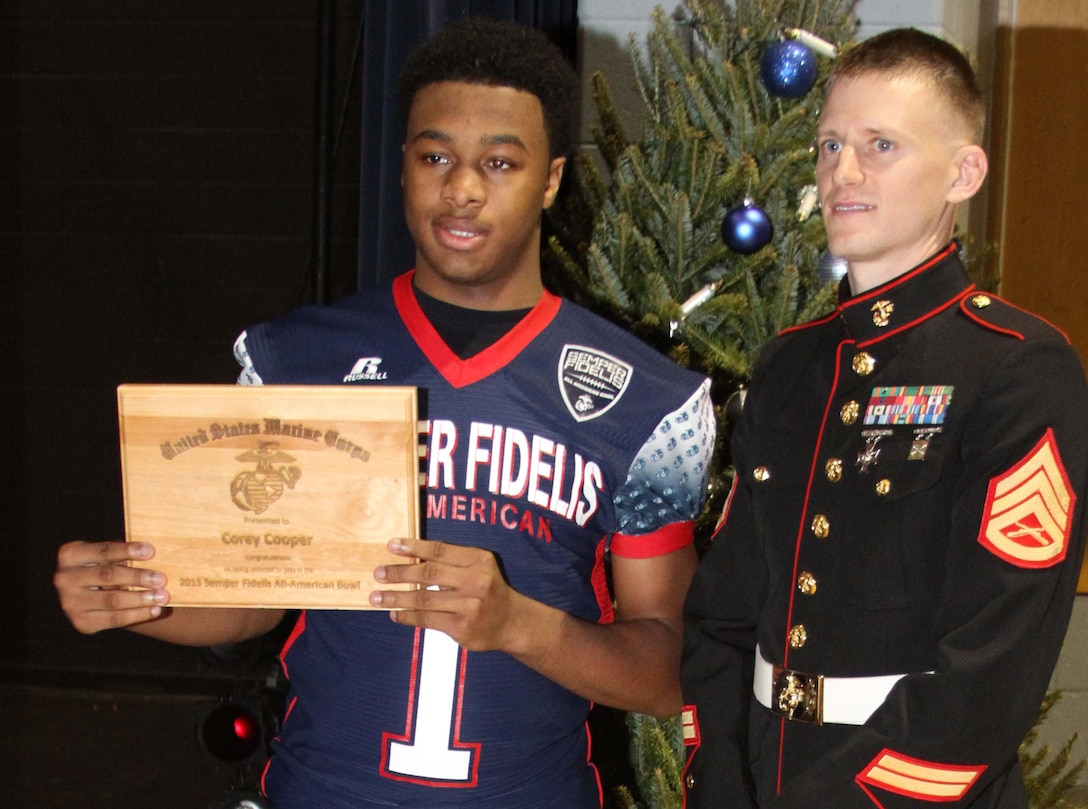 Corey Cooper, a wide receiver with the Millbrook High School football team, poses with Staff Sgt. James Ramsey, a recruiter with Marine Corps Recruiting Station Raleigh, after a Semper Fi All-American Bowl jersey presentation at Millbrook High School in Raleigh, N.C., December 11, 2012. Corey Cooper was selected to play in the Semper Fi All-American Bowl on January 4, 