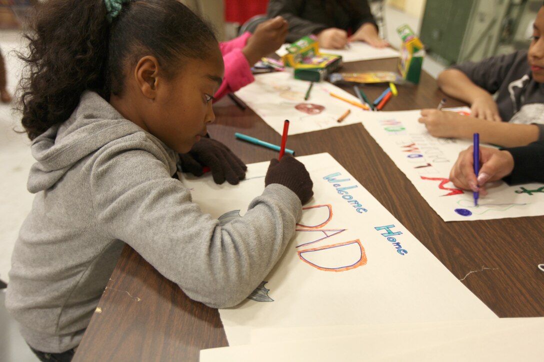 Emily Benjamin, 8, from Murrieta, Calif., makes a welcome home sign for her father, Chief Warrant Officer 3 Eddie Benjamin, a tactical communications planning and operations officer with I Marine Expeditionary Force (Forward), during his homecoming at Camp Pendleton, Calif., Feb. 6. The homecoming marks the first wave for I MEF (FWD) to return from Afghanistan. The entire unit is scheduled to return by mid-March.


