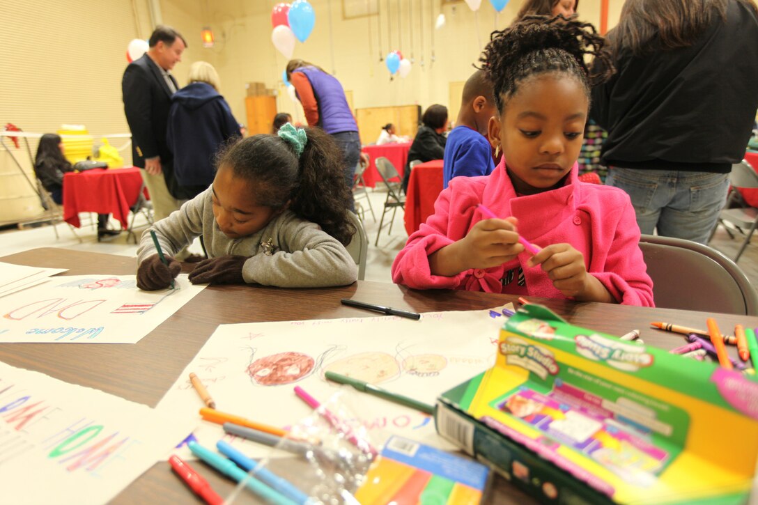 Emily Benjamin, 8 from Murrieta, Calif., and Amaya Hodges, 8, from San Diego, make welcome home signs for their fathers during a homecoming at Camp Pendleton, Calif., Feb. 6. The homecoming marks the first wave for I Marine Expeditionary Force (Forward) to return from Afghanistan. The entire unit is scheduled to return by mid-March.




