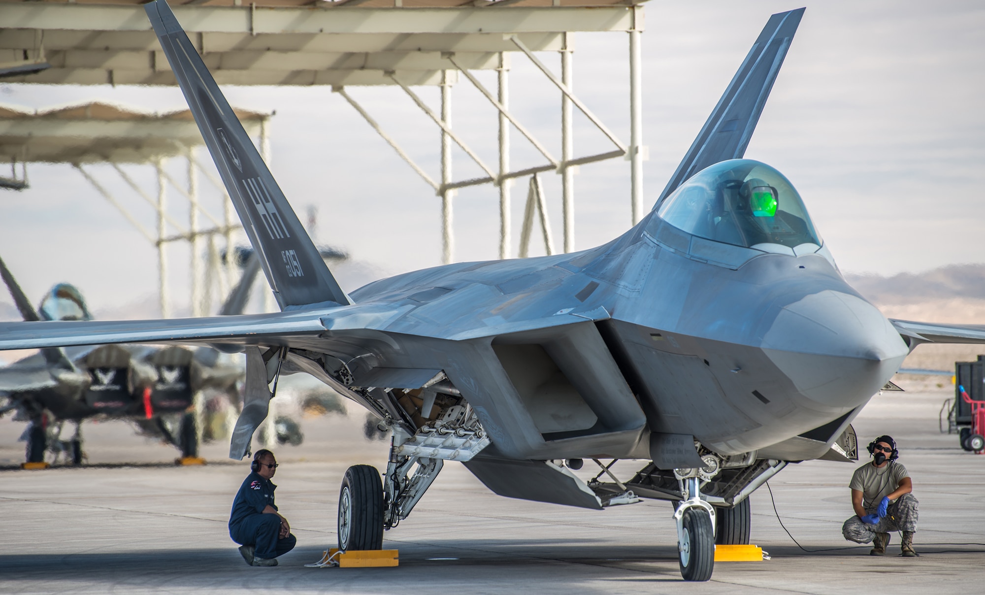 Maintainers deployed from the 15th Wing and 154th Wing, Air National Guard, crew conduct pre-flight checks prior to launching an F-22 Raptor in support of Red Flag 13-2 from 21 Jan. through 1 Feb., at Nellis Air Force Base, Nevada. More than 100 aircraft depart the base twice a day to participate in a wide-variety of missions designed to provide Airmen realistic combat training. (Courtesy photo/Ervin Booker)
