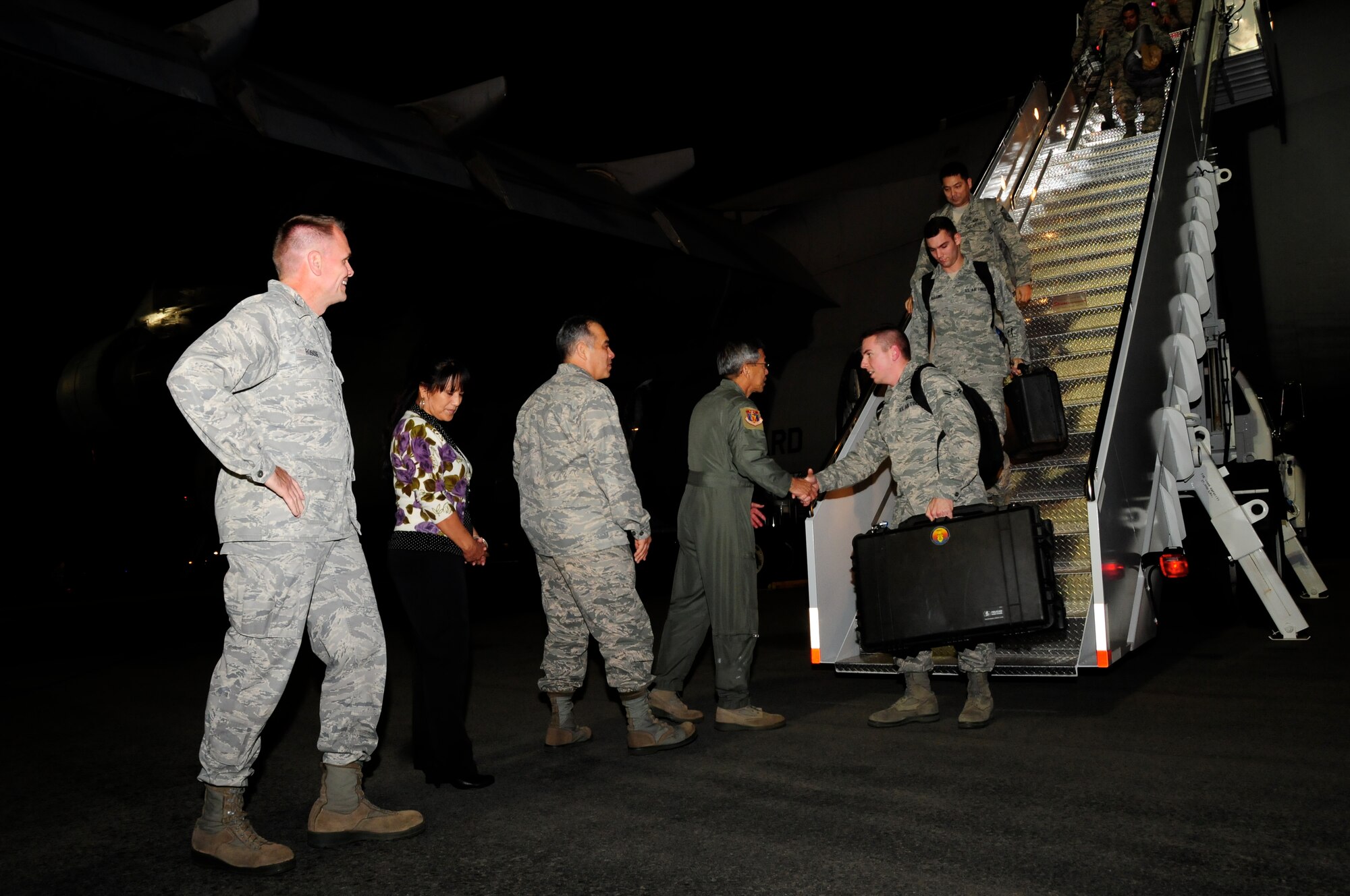 Col. John Roscoe, 15th Wing commander, Brig. Gen. Braden Sakai, 154th Wing, Hawaii Air National Guard, commander, and his wife, along with Maj. Gen. Darryll Wong, state adjutant general, welcome maintainers from the 15th Wing and 154th Wing, Air National Guard, back from Red Flag 13-2 on Feb. 2, 2013. An integrated team of 152 active duty, HIANG and contracted personnel contributed to the successful completion of the two-week Red Flag exercise at Nellis Air Force Base, Nevada, as part of the Hawaiian Raptor’s first over-water deployment. (Air National Guard photo/Senior Master Sgt. Kristen M. Stanley)