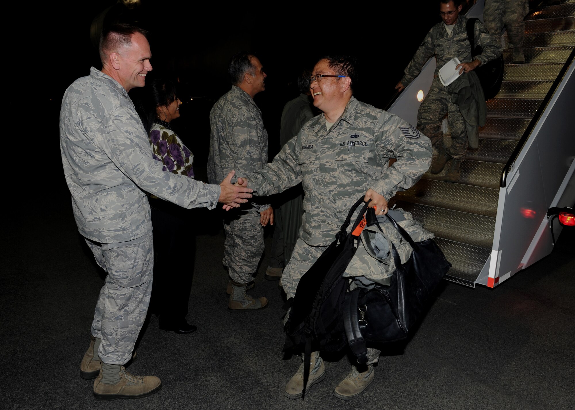 Col. John Roscoe, 15th Wing commander, along with Brig. Gen. Braden Sakai, 154th Wing, Hawaii Air National Guard, commander and his wife, welcome Tech. Sgt. Jay Nishimura, 154th Aircraft Maintenance Squadron F-22 avionics systems specialist, back from Red Flag 13-2 on Feb. 2, 2013. Nishimura, in addition to 151 other integrated active duty, HIANG and contracted personnel, contributed to the successful completion of the two-week long Red Flag exercise at Nellis Air Force Base, Nevada, as part of the Hawaiian Raptor’s first over-water deployment. (U.S. Air Force photo/Staff Sgt. Terri Barriere)