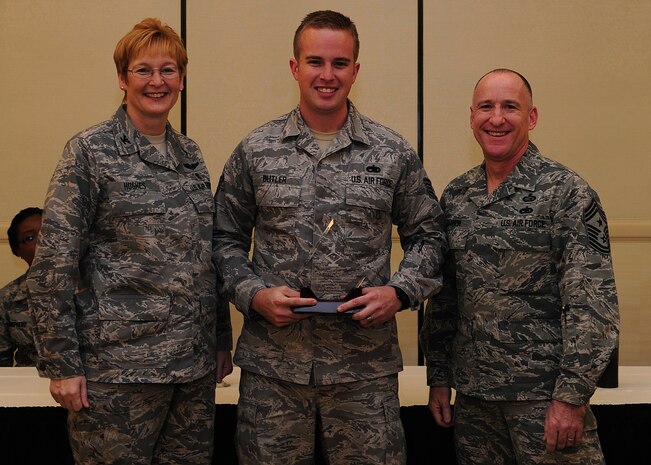 Colonel Judith Hughes, 628th Medical Group commander, and Chief Master Sgt. Al Hannon, 628th Air Base Wing command chief, recognize Staff Sgt. Kristan Butler, 373rd Training Squadron, Detachment 5 instructor, as a Diamond Sharp award winner during a ceremony at the Charleston Club, Feb. 4, 2013, at Joint Base Charleston - Air Base, S.C. (U.S. Air Force photo/ Staff Sgt. Rasheen Douglas)