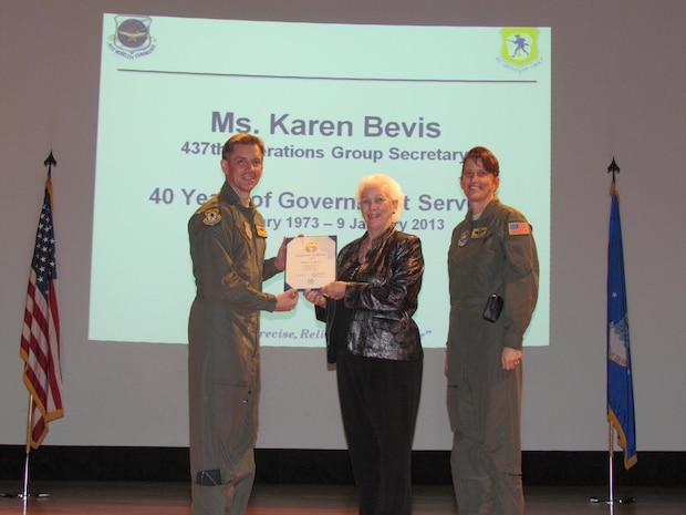 Col. Trevor Nitz, 437th Operations Group commander, and Chief Master Sgt. Jeanette King, 437th OG command chief present Karen Bevis, 437th OG secretary, with a certificate for her 40 years in the civil service Jan. 18, 2013, at Joint Base Charleston - Air Base. (Courtesy photo)