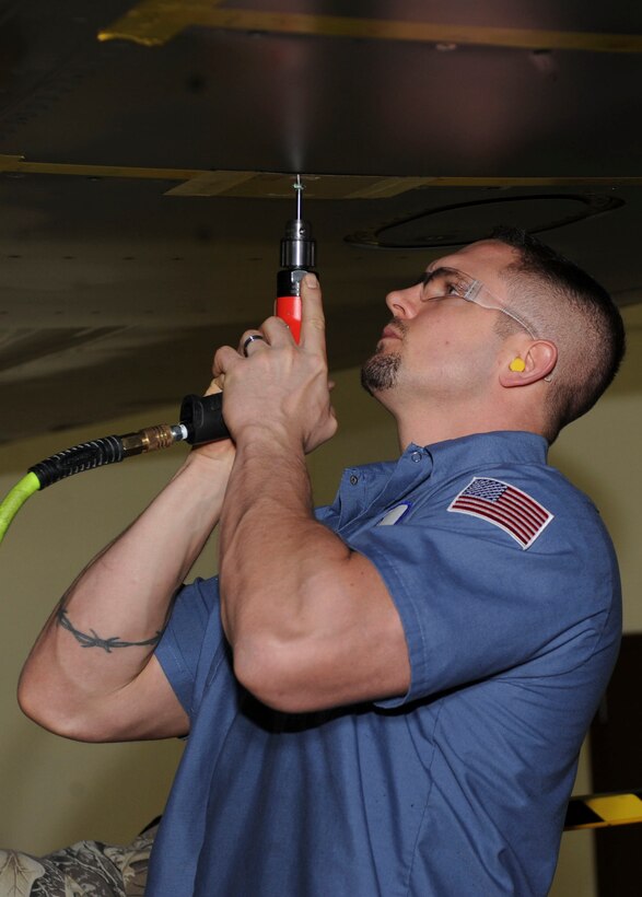Jeremy Luder, Boeing structural mechanic, repairs a cracked hole underneath a B-1 bomber’s wing during a time compliance technical order inspection at Ellsworth Air Force Base, S.D., Jan. 23, 2013. TCTOs provide instructions to modify military systems or commodities within specified time limits, initiate special one-time inspections, or impose temporary restrictions and track configuration on systems or equipment. (U.S. Air Force photo by Airman 1st Class Anania Tekurio/Released)