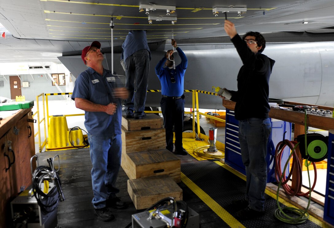 Members of Ellsworth’s Boeing structural mechanics team inspect the lower surface of a B-1 bomber’s wing during a time compliance technical order inspection at Ellsworth Air Force Base, S.D., Jan. 23, 2013. This particular TCTO inspection is to assess and identify any possible fatigue or cracking within the wing and ultimately ensure a safe and healthy fleet. (U.S. Air Force photo by Airman 1st Class Anania Tekurio/Released)  