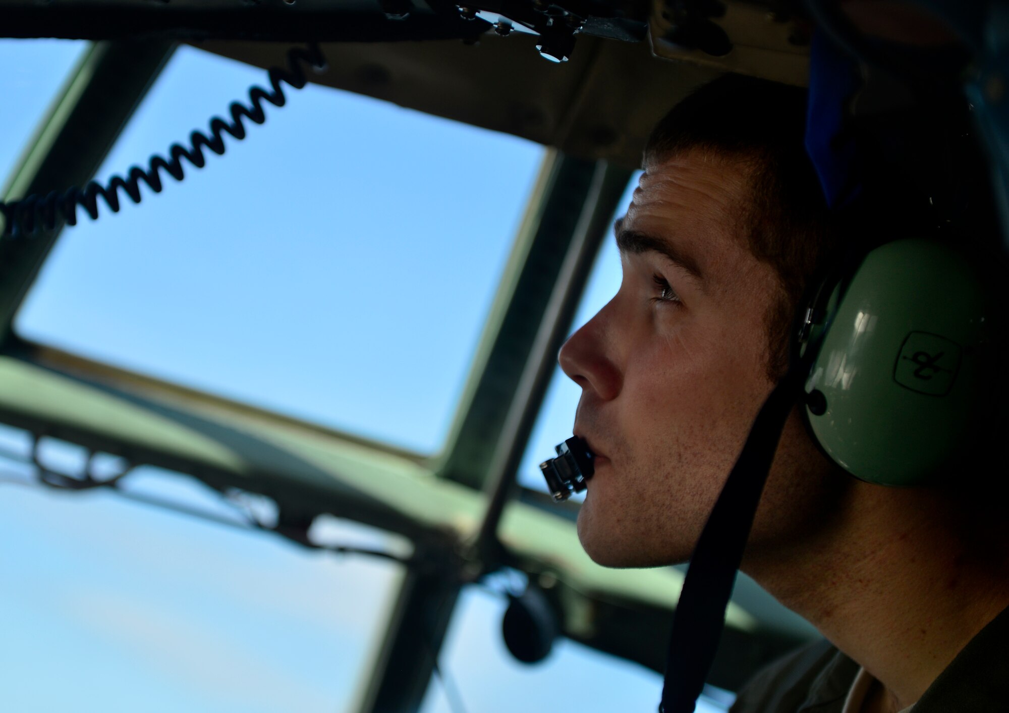 U.S. Air Force 1st Lt. Karl Weigert, a C-130H navigator with the 36th Airlift Squadron, Yokota Air Base Japan, looks out the window of his aircraft during a humanitarian aid and disaster relief flight while supporting Cope North 13 on Anderson Air Force Base, Guam, Feb. 6, 2013. Cope North is an annual air combat tactics, humanitarian assistance and disaster relief exercise designed to increase the readiness and interoperability of the U.S. Air Force, Japan Air Self-Defense Force and Royal Australian Air Force. (U.S. Air Force photo by Senior Airman Matthew Bruch/Released)