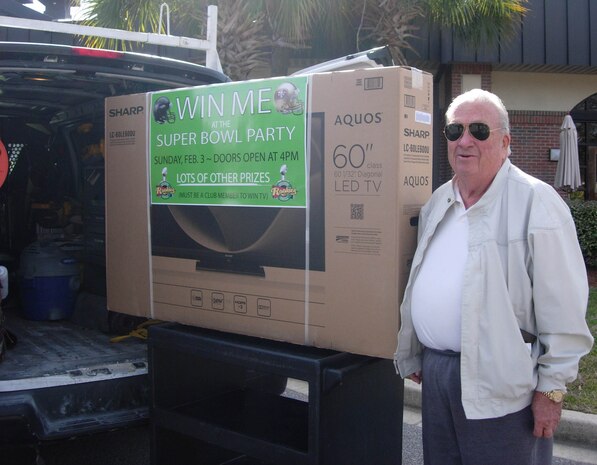 Robert Schoenleber displays his 60” LED TV he won at the Charleston Club’s Super Bowl Party Feb. 3, 2013. “I was sitting in Rookies, right in front of the bartender who was pulling the names for all of the prizes,” Schoenleber said. “When the bartender called my name, everyone was joking that the drawing was rigged!” Schoenleber has been a Charleston Club member since the 1960s. A Charleston Club Membership drive is now in progress and new members can enjoy dozens of benefits. Stop by the Charleston Club or Redbank Club offices to apply or for more details on Club Membership. (Courtesy photo)