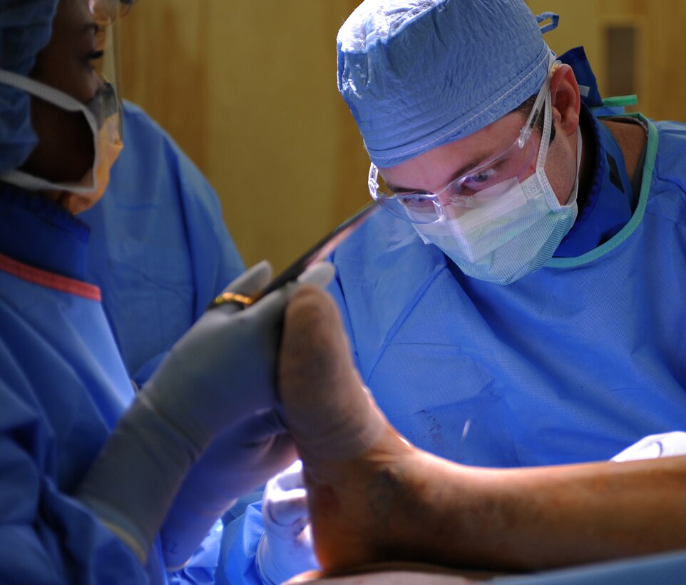 U.S. Air Force Maj. Michael Tompkins, M.D., 633rd Surgical Operations Squadron orthopedic surgeon, operates on a patient’s fractured ankle at Langley Air Force Base, Va., Feb. 5, 2013. The Langley Hospital Orthopedic Clinic staff focus  on personalized care and put emphasis on a patient-centric approach to medicine. (U.S. Air Force photo by Senior Airman Teresa Aber/Released)