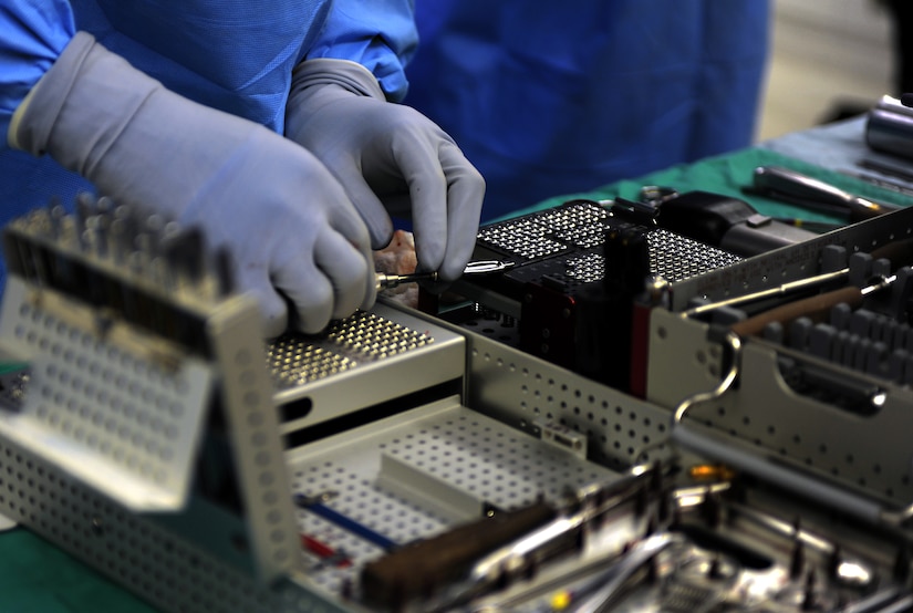 U.S. Air Force Airman 1st Class Ryan Donaldson, 633rd Surgical Operations Squadron surgical technician, verifies proper screws are being used before handing them to the orthopedic surgeon during a procedure at Langley Air Force Base, Va., Feb. 5, 2013. Orthopedic surgerons use both surgical and nonsurgical means to treat musculoskeletal trauma, sports-related injuries, degenerative diseaes, infections, tumors and congenital disorders. (U.S. Air Force photo by Senior Airman Teresa Aber/Released)