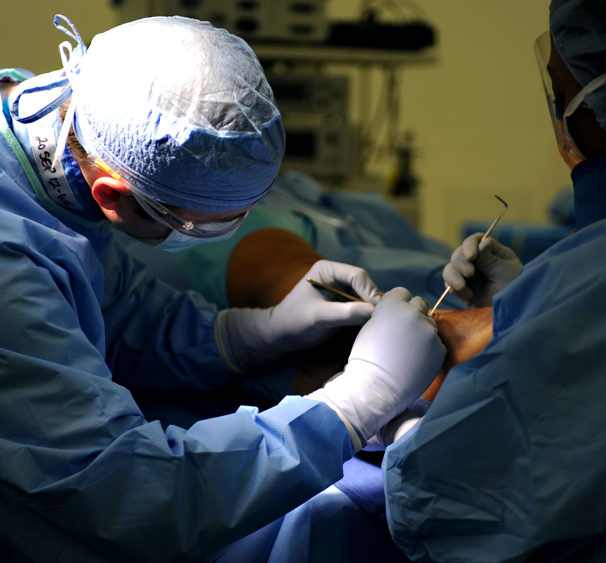 U.S. Air Force Maj. Michael Tompkins, M.D., 633rd Surgical Operations Squadron orthopedic surgeon, operates on a patient’s fractured ankle at Langley Air Force Base, Va., Feb. 5, 2013. Orthopedic injuries result in more than 7 million hospitalizations each year. (U.S. Air Force photo by Senior Airman Teresa Aber/Released)