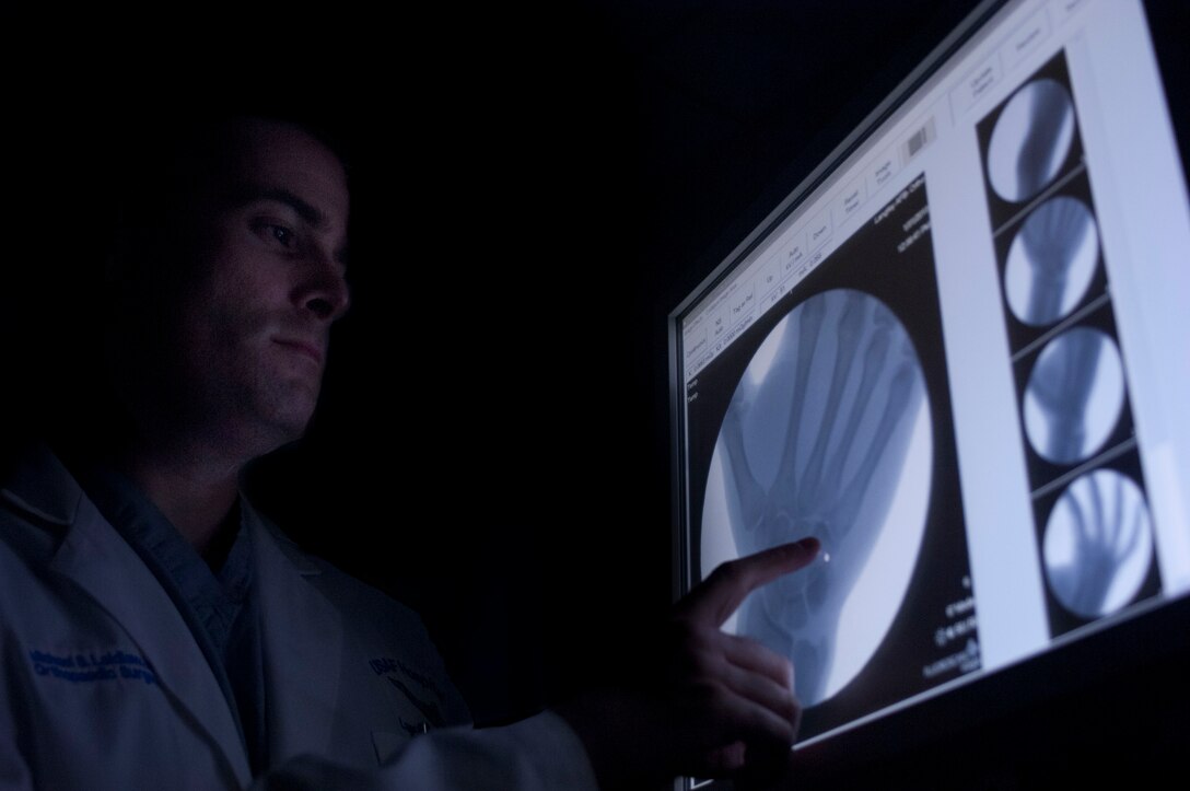 U.S. Air Force Dr. [Maj.] Michael Laidlaw, 633rd Surgical Operations Squadron, director of orthopedic services, examines an X-ray at the Orthopedics clinic inside the new multi-specialty health center at U.S. Air Force Hospital Langley at Langley Air Force Base, Va., Jan. 31, 2013. The orthopedic surgery clinic has a staff of five orthopedic surgeons and two physician assistants who provide a wide range of services, including treatment of sports-related injuries, joint replacements and acute musculoskeletal care. (U.S. Air Force photo by Airman 1st Class R. Alex Durbin/Released)