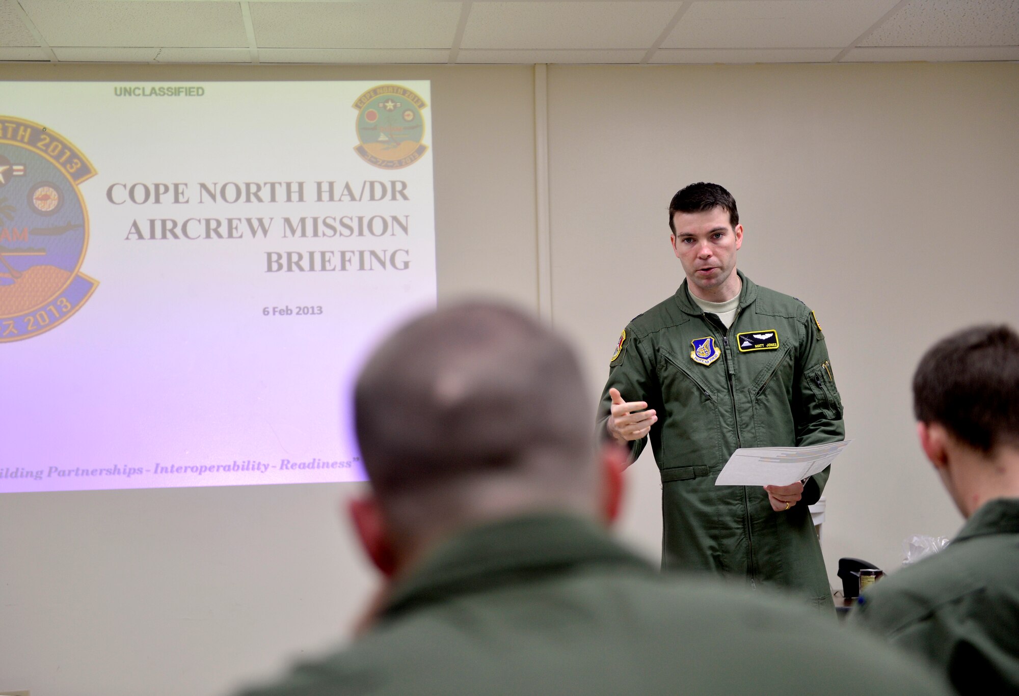 U.S. Air Force Capt. Matt Jones presents a mission brief to C-130H crews before a humanitarian aid and disaster relief flight in support of Cope North 13 on Anderson Air Force Base, Guam, Feb. 6, 2013.  The flight took passengers and cargo to the islands of Saipan and Tinian.  Cope North is an annual air combat tactics, humanitarian assistance and disaster relief exercise designed to increase the readiness and interoperability of the U.S. Air Force, Japan Air Self-Defense Force and Royal Australian Air Force. (U.S. Air Force photo by Senior Airman Matthew Bruch/Released)
