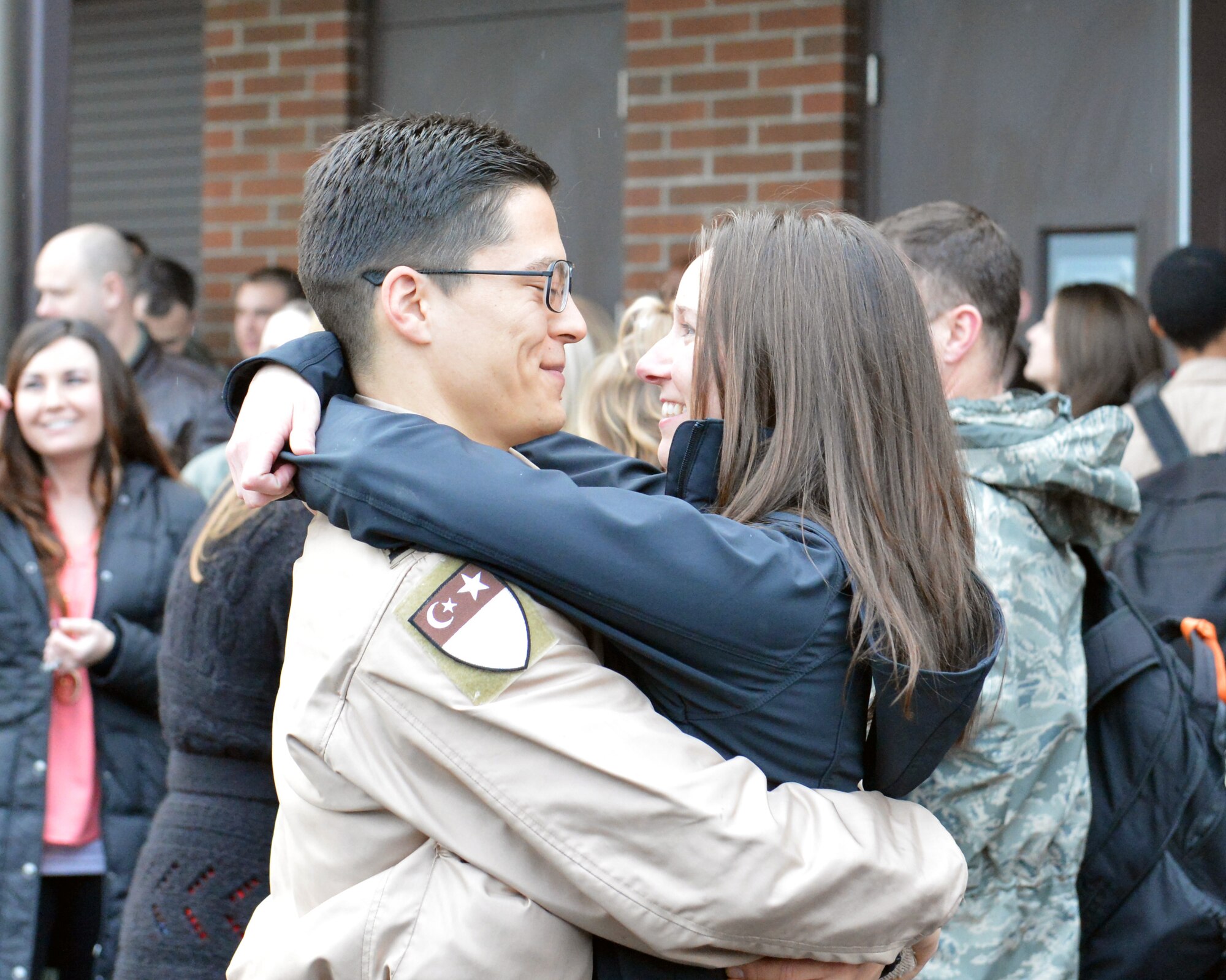 Capt. Phil Sakamoto (right), 10th Airlift Squadron pilot, reunites with his wife, Saralyn, after returning from a 60-day deployment, Feb. 5, 2012, at Joint Base Lewis-McChord, Wash. The 10th AS deployed as the 817th Expeditionary Airlift Squadron to provide global strategic airlift, airdrop, aeromedical evacuation and humanitarian relief, to create an air bridge for personnel, equipment and supplies throughout the assigned areas of responsibility.(U.S. Air Force photo/Staff Sgt. Jason Truskowski)