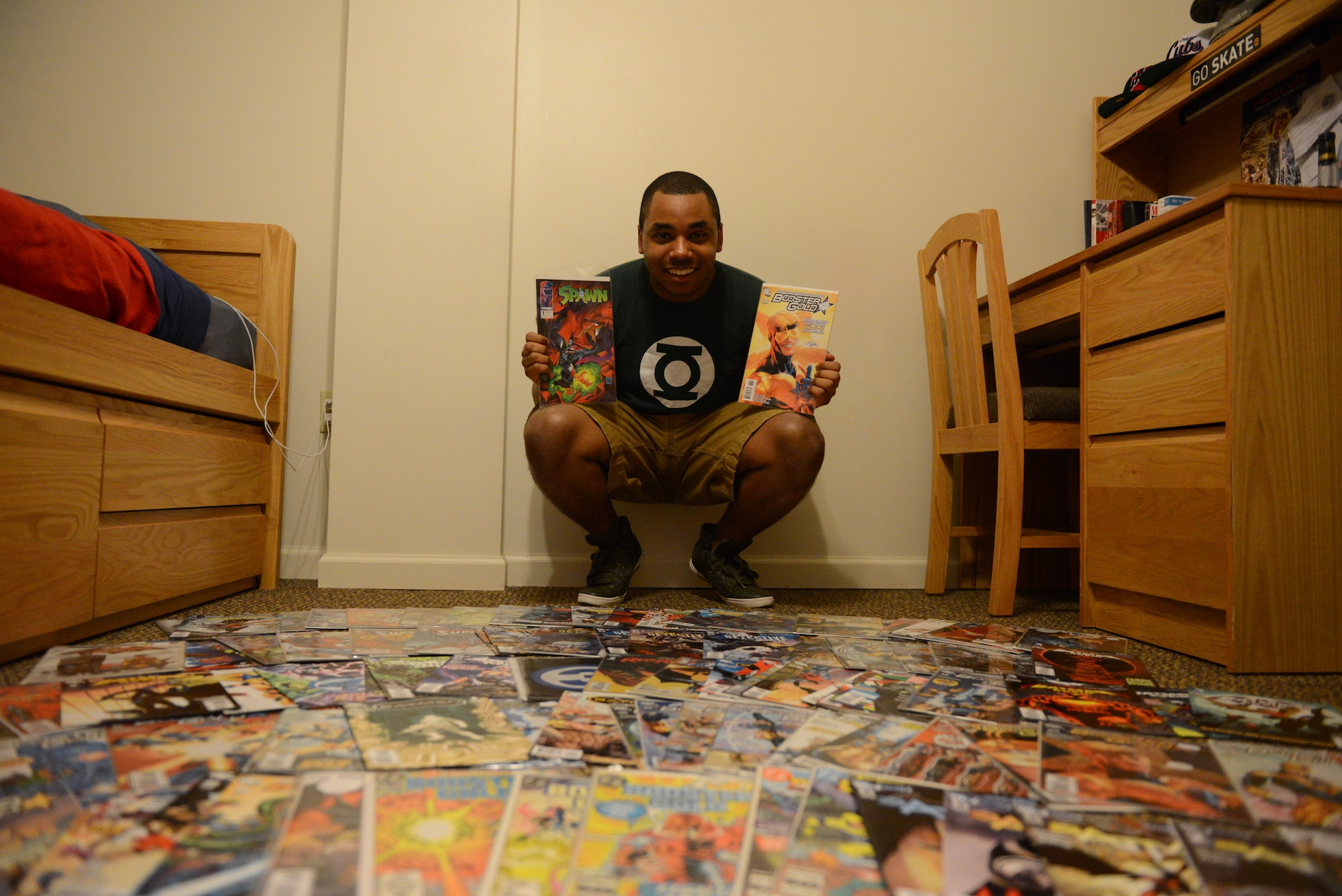Airman 1st Class Jeremy Evans, 375th Communication Squadron, sorts through his comic book collection Monday in his dorm room at Scott Air Force Base.  Evans has an extensive collection of more than 1,000 comic books. (U.S. Air Force photo/Airman 1st Class Jake Eckhardt)