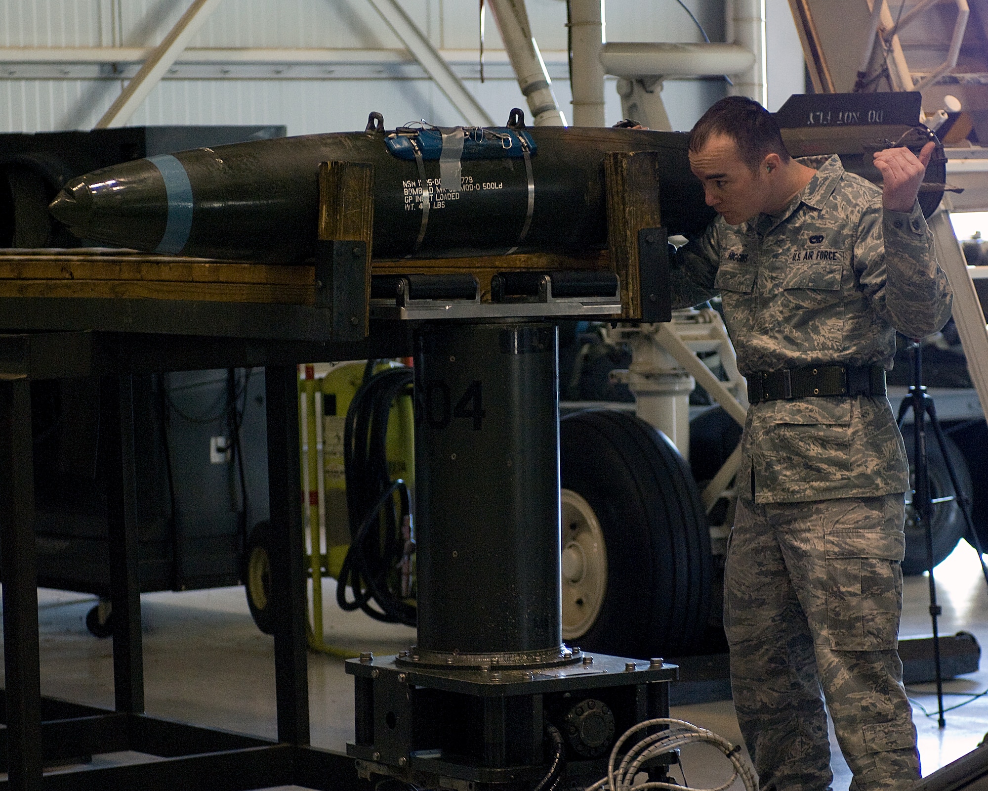 Senior Airman Michael Higgens, 7th Aircraft Maintenance Squadron, directs a MK-82 onto a munitions lift during the Weapons Load Crew of the Year competition Feb. 1, 2013, at Dyess Air Force Base, Texas. The competition was comprised of loading four different munitions into a B-1 simulator while being evaluated on their use of checklists, safety procedures, and overall speed.  (U.S. Air Force photo by Airman 1st Class Kylsee Wisseman/Released)