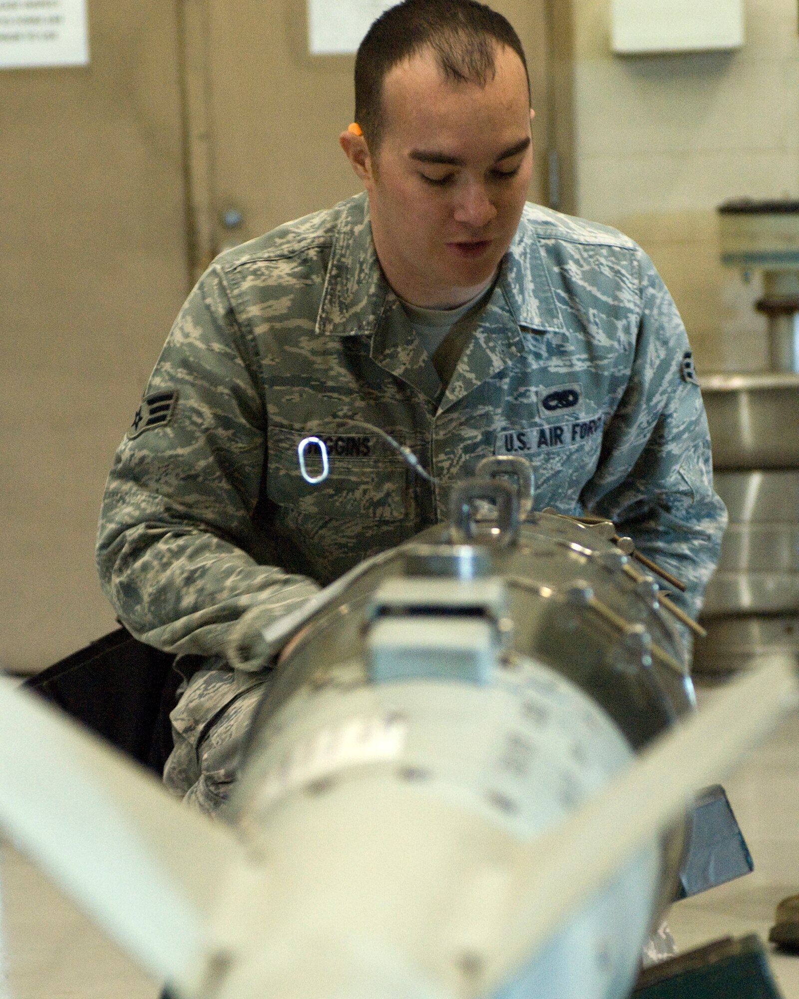Senior Airman Michael Higgens, 7th Aircraft Maintenance Squadron, inspects a GBU-54 guided bomb during the Weapons Load Crew of the Year competition Feb. 1, 2013, at Dyess Air Force Base, Texas. The competition was comprised of loading four different munitions into a B-1 simulator while being evaluated on their use of checklists, safety procedures, and overall speed. (U.S. Air Force photo by Airman 1st Class Kylsee Wisseman/Released)