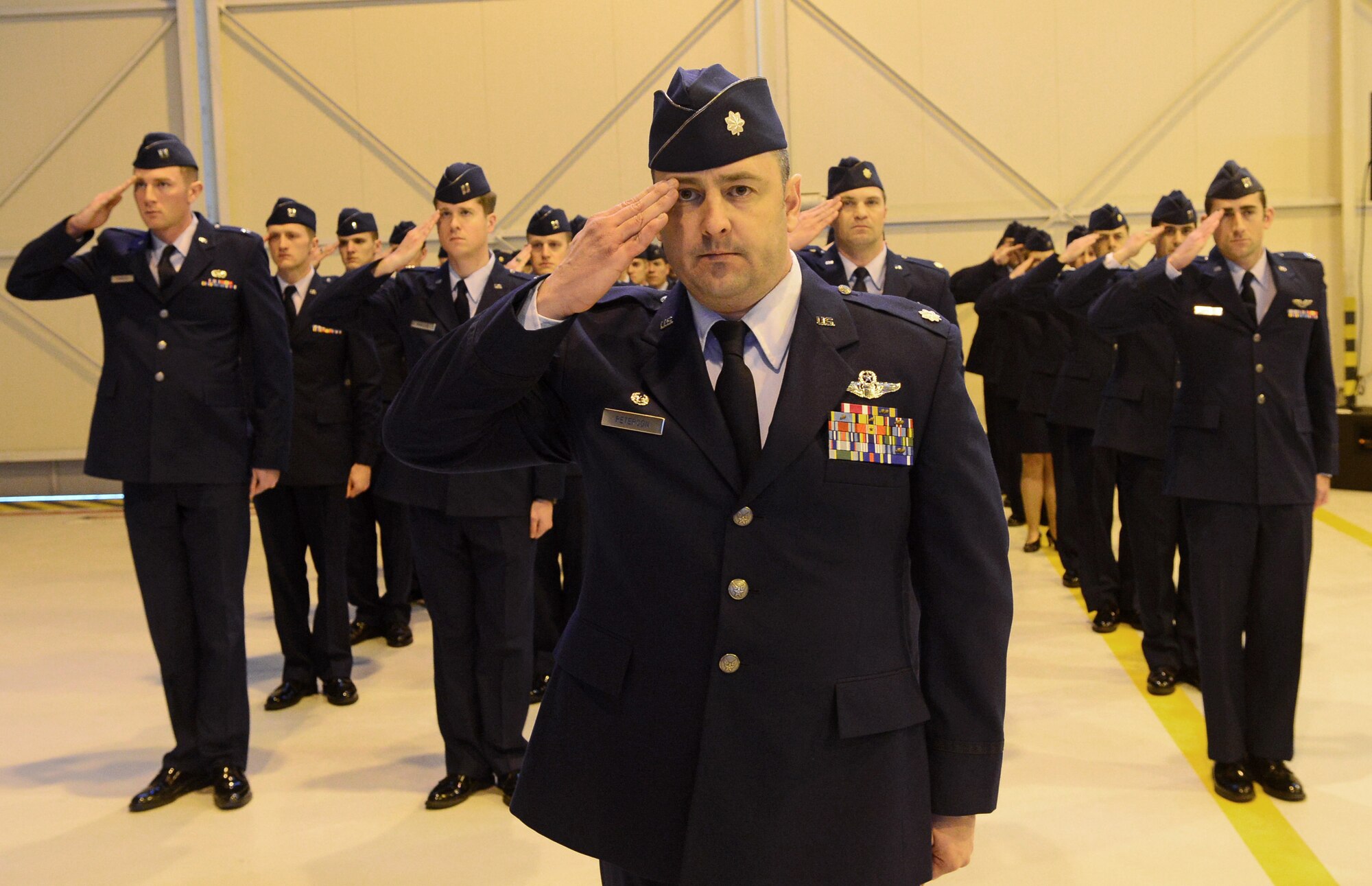 Lt. Col. John Peterson, 555th Fighter Squadron commander and the 555th Fighter Squadron salute during a memorial service on Aviano Air Base, Italy, Feb. 6, 2013. Approximately 1,000 people attended the memorial service for Gruenther, who past away when his F-16 went down over the Adriatic Sea Jan. 28. (U.S. Air Force photo/Airman 1st Class Matthew Lotz)