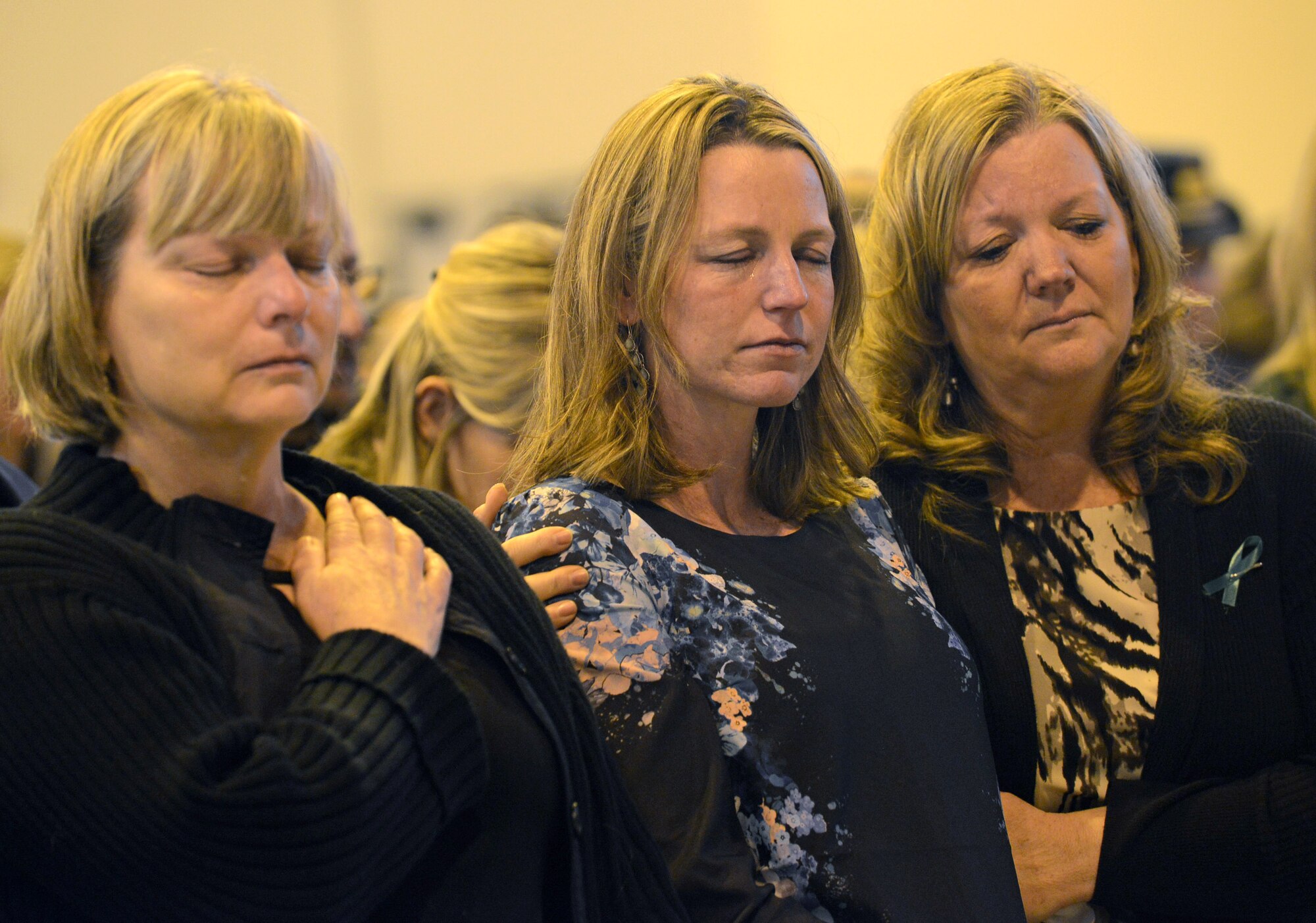 Family of U.S. Air Force Maj. Lucas Gruenther prays during a memorial service on Aviano Air Base, Italy, Feb. 6, 2013. Approximately 1,000 people attended the memorial service for Gruenther, who lost his life when his aircraft went down during a training mission on Jan. 28. (U.S. Air Force photo/Airman 1st Class Matthew Lotz)