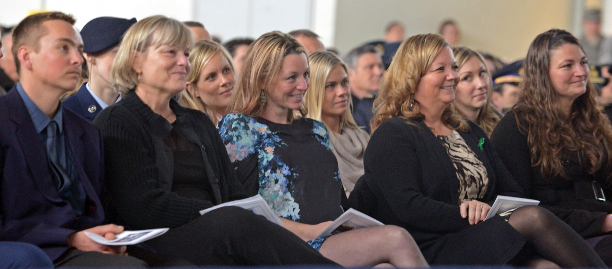 U.S. Air Force Maj. Lucas Gruenther's family smiles during a video at a memorial service on Aviano Air Base, Italy, Feb. 6, 2013. Approximately 1,000 people attended the memorial service for Gruenther, who lost his life when his aircraft went down during a training mission on Jan. 28. (U.S. Air Force photo/Airman 1st Class Matthew Lotz)