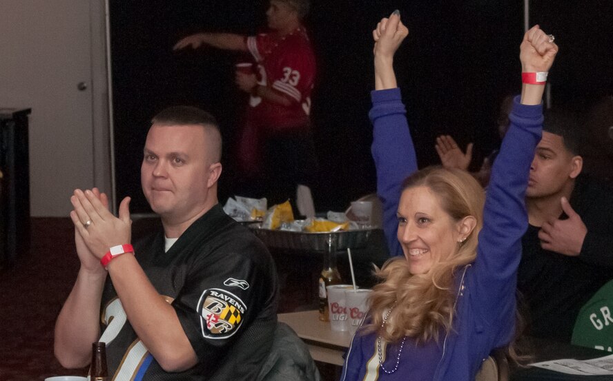 HANSCOM AIR FORCE BASE, Mass. – Paul and Kelly Cooper celebrate after a Baltimore Ravens touchdown during “Super” Frenzy at the Minuteman Commons Feb. 3. The Hanscom community gathered at the Commons to watch the Super Bowl and enjoy food, games, prizes and giveaways. (U.S. Air Force photo by Rick Berry)