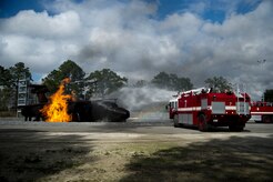 A 628th Civil Engineer Squadron fire truck shoots water at the flames on a static training aircraft Jan. 30, 2013, at Joint Base Charleston - Air Base, S.C. During the live fire burn exercise, firefighters practiced shooting precision bursts of water to extinguish the fire. This training is part of preparation for real world emergencies. (U.S. Air Force photo/Staff Sgt. Rasheen Douglas)