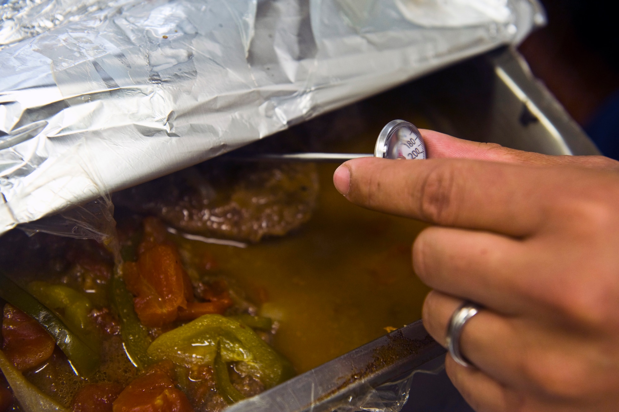 U.S. Air Force Senior Airman Eliceo Dejesus, 99th Force Support Squadron services journeyman, checks the temperature of food at the Crosswinds Dining Facility, Feb. 5, 2013, on Nellis Air Force Base, Nev. The 99th FSS is currently in
the running for this year's Hennessy Award.  The Hennessy Award is presented to Air Force installations having the best food service program in the Air Force. (U.S. Air Force photo/Senior Airman Brett Clashman)