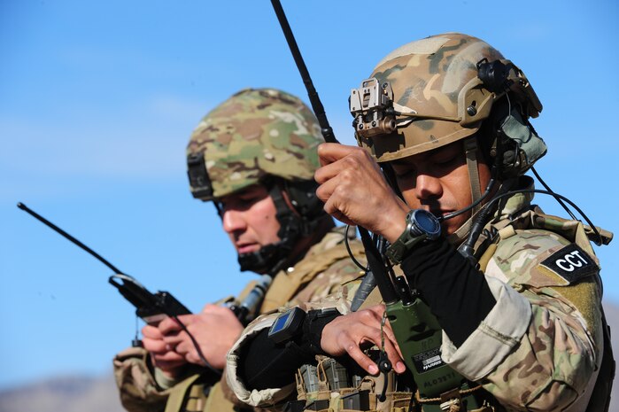 Tech. Sgt. Francisco Corona, 6th Combat Training Squadron Tactical Air Control Party, and Staff Sgt. David Dunn, 321st Special Tactics Squadron combat controller, check the frequency on their radios during the Joint Terminal Air Controller Advanced Instructor Course at the Nevada Test and Training Range Jan. 28, 2013. Both Airmen are JTAC qualified and are experts in controlling attacks from the air and from artillery. (U.S. Air Force photo by Staff Sgt. William P. Coleman)