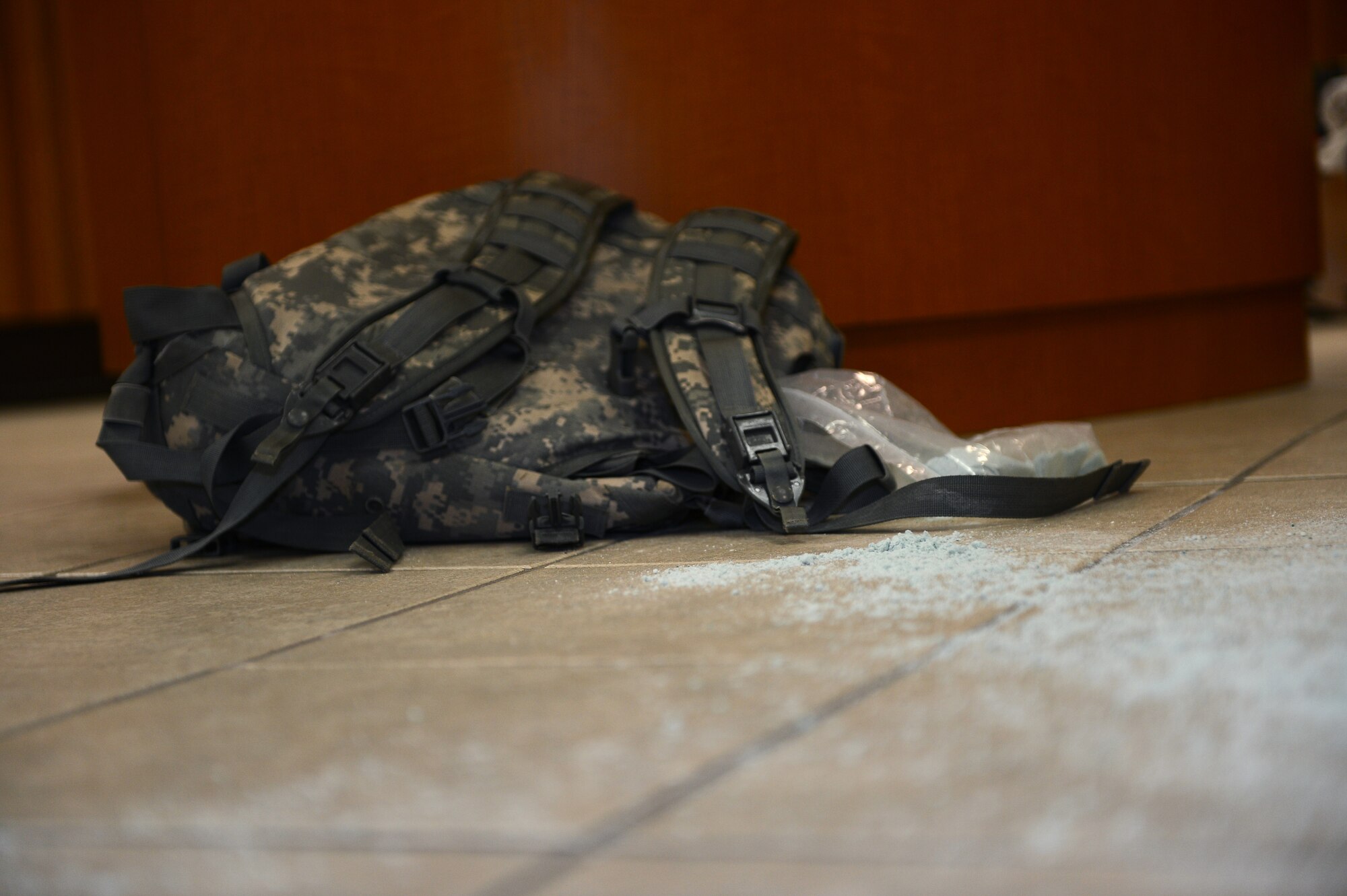 SPANGDAHLEM AIR BASE, Germany – A backpack containing simulated hazardous chemical agents rests against a table inside the Community Bank on base Feb. 5, 2013. The package was used in an exercise scenario that tested the base’s ability to respond quickly and effectively to suspicious package and hazardous materials situations. (U.S. Air Force photo by Senior Airman Dillon Davis/Released)