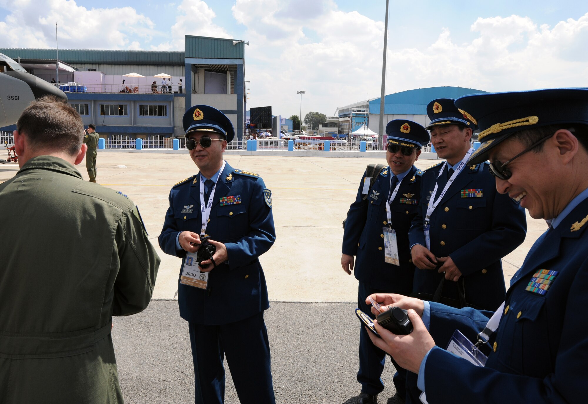 A member of the Chinese delegation to the Aero India 2013 air show smiles after receiving a Pacific Air Forces C-17 demonstration team patch from Capt. Bill Greer, the team’s ground coordinator, at Air Force Station Yelahanka, Bangalore, India, Feb. 6. The air show allowed the crew of the C-17 to interact with numerous members of international militaries and discuss the capabilities of their aircraft. The U.S. military was represented by a F-16 demonstration team and a KC-135 static display in addition to the C-17. (U.S. Air Force photo by Capt. Ben Sakrisson)