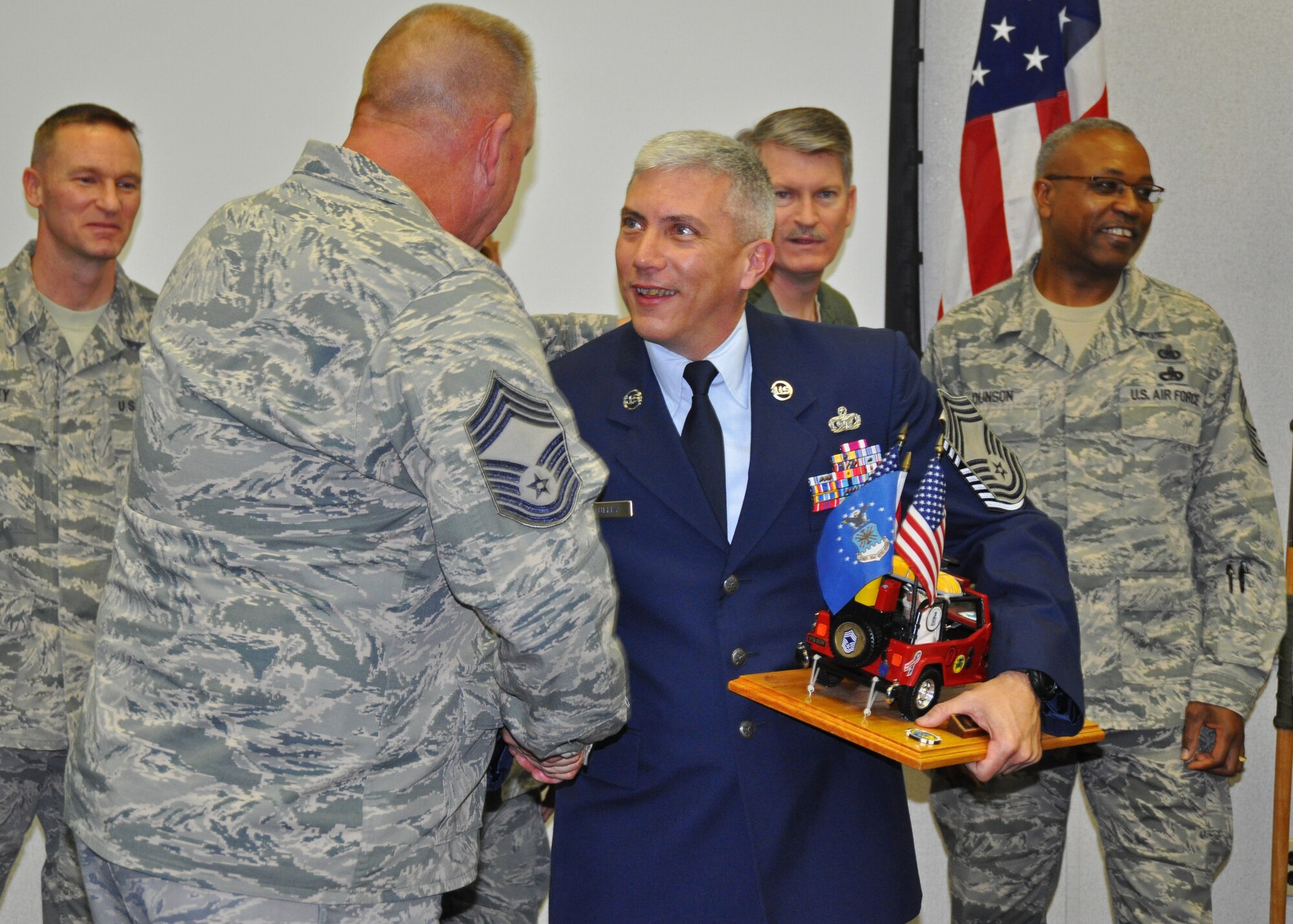 Air Force Reserve Chief Master Sgt. Ronald McCully, 919th Security Forces Squadron, receives congratulations during a ceremony inducting him into the Air Force's highest enlisted rank Feb. 3, 2012 at Duke Field, Fla.  McCulley clutches a special Jeep memento which, according to Air Force tradition, he must guard at all times until the next Duke Field chief is similarly inducted. (U.S. Air Force photo/Dan Neely) 