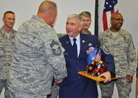 Air Force Reserve Chief Master Sgt. Ronald McCully, 919th Security Forces Squadron, receives congratulations during a ceremony inducting him into the Air Force's highest enlisted rank Feb. 3, 2012 at Duke Field, Fla.  McCulley clutches a special Jeep memento which, according to Air Force tradition, he must guard at all times until the next Duke Field chief is similarly inducted. (U.S. Air Force photo/Dan Neely) 
