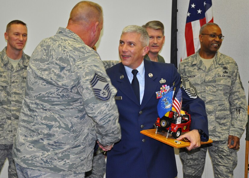 Air Force Reserve Chief Master Sgt. Ronald McCully, 919th Security Forces Squadron, receives congratulations during a ceremony inducting him into the Air Force's highest enlisted rank Feb. 3, 2012 at Duke Field, Fla.  McCulley clutches a special Jeep memento which, according to Air Force tradition, he must guard at all times until the next Duke Field chief is similarly inducted. (U.S. Air Force photo/Dan Neely) 