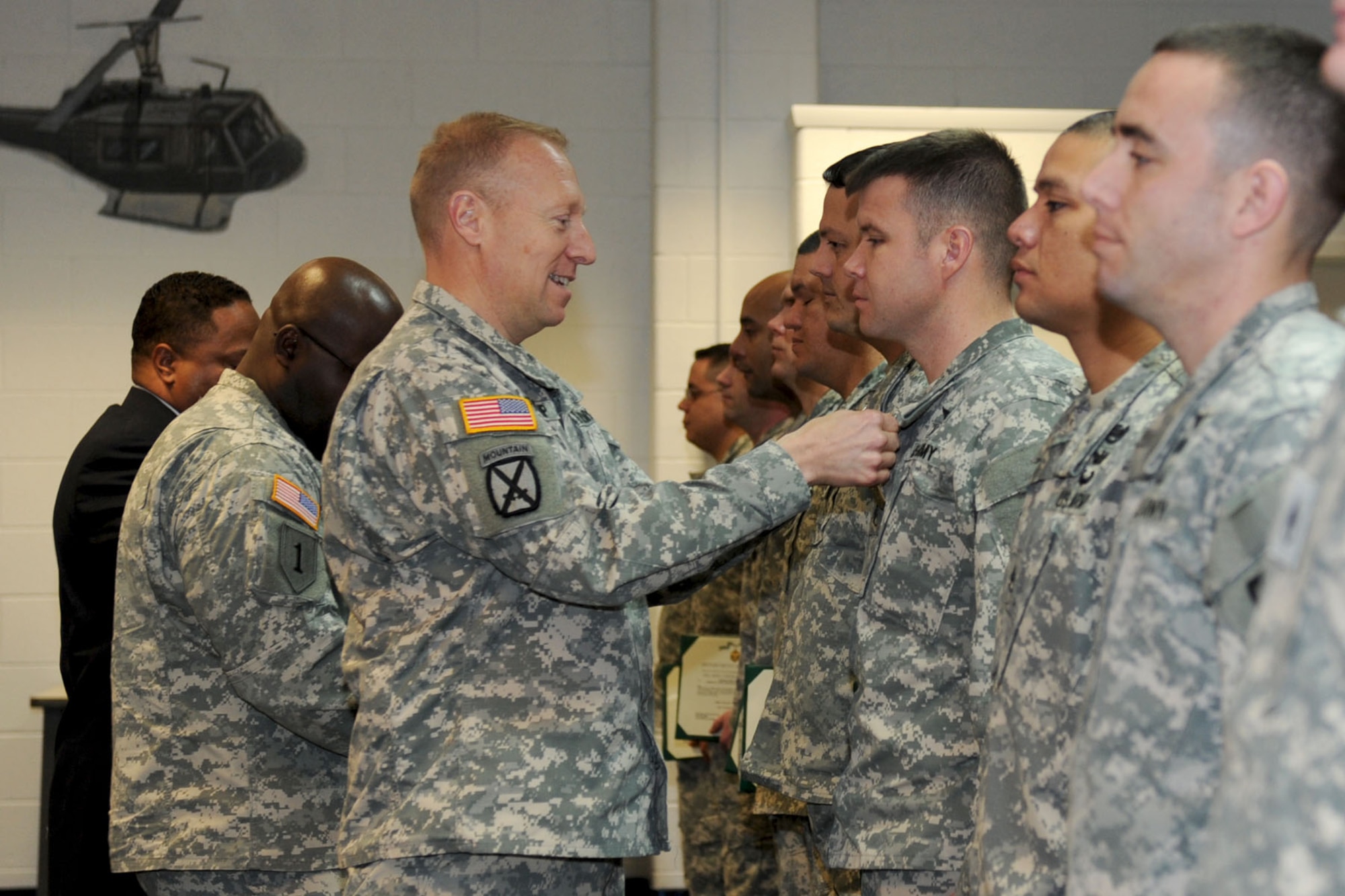 U.S. Army Col. Dean Heitkamp, 128th Aviation Brigade commander, (left), presents Army Commendation Medals to newly-selected Master Instructors during an awards ceremony at Fort Eustis, Va., Feb. 1, 2013. The title of Master Instructor is the highest certification a Soldier may receive during their Army Advanced Individual Training career. (U.S. Air Force photo by Staff Sgt. Ashley Hawkins/Released)