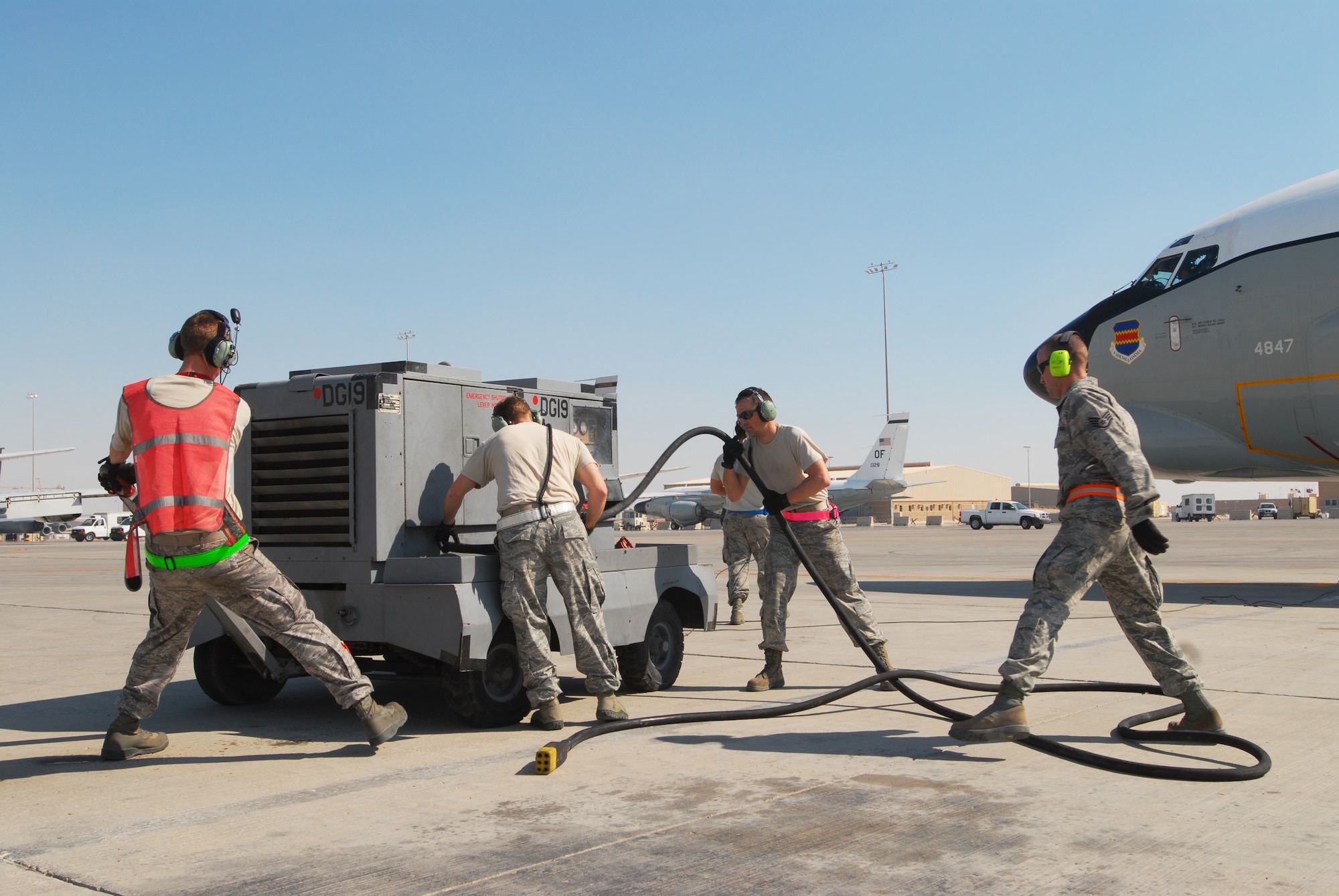 SOUTHWEST ASIA -- Maintainers of the 763rd Expeditionary Aircraft Maintenance Unit prepare to stow a portable power unit as a RC-135 Combat Sent prepares to taxi out, Feb. 2. Deployed from Offutt Air Force Base, Neb., members of the 55th Aircraft Maintenance Squadron serve as the 763rd Expeditionary Aircraft Maintenance Unit for the 379th Air Expeditionary Wing in Southwest Asia. The Rivet Joint program they support generates airpower for real-time collection, analysis and dissemination of signal intelligence to provide air dominance over the area of operations. (U.S. Air Force photo/Master Sgt. Christian Michael)