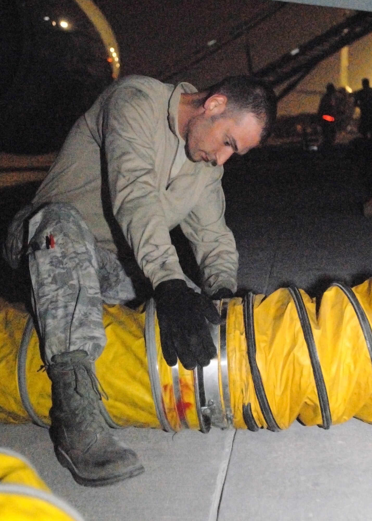 SOUTHWEST ASIA -- Tech. Sgt. Tanner Wegner seals air conditioning hoses used to cool the fuselage and compartments of a RC-135 Rivet Joint shortly after landing in Southwest Asia, Feb. 2. Deployed from Offutt Air Force Base, Neb., members of the 55th Aircraft Maintenance Squadron serve as the 763rd Expeditionary Aircraft Maintenance Unit for the 379th Air Expeditionary Wing in Southwest Asia. The Rivet Joint program they support generates airpower for real-time collection, analysis and dissemination of signal intelligence to provide air dominance over the area of operations. (U.S. Air Force photo/Master Sgt. Christian Michael)