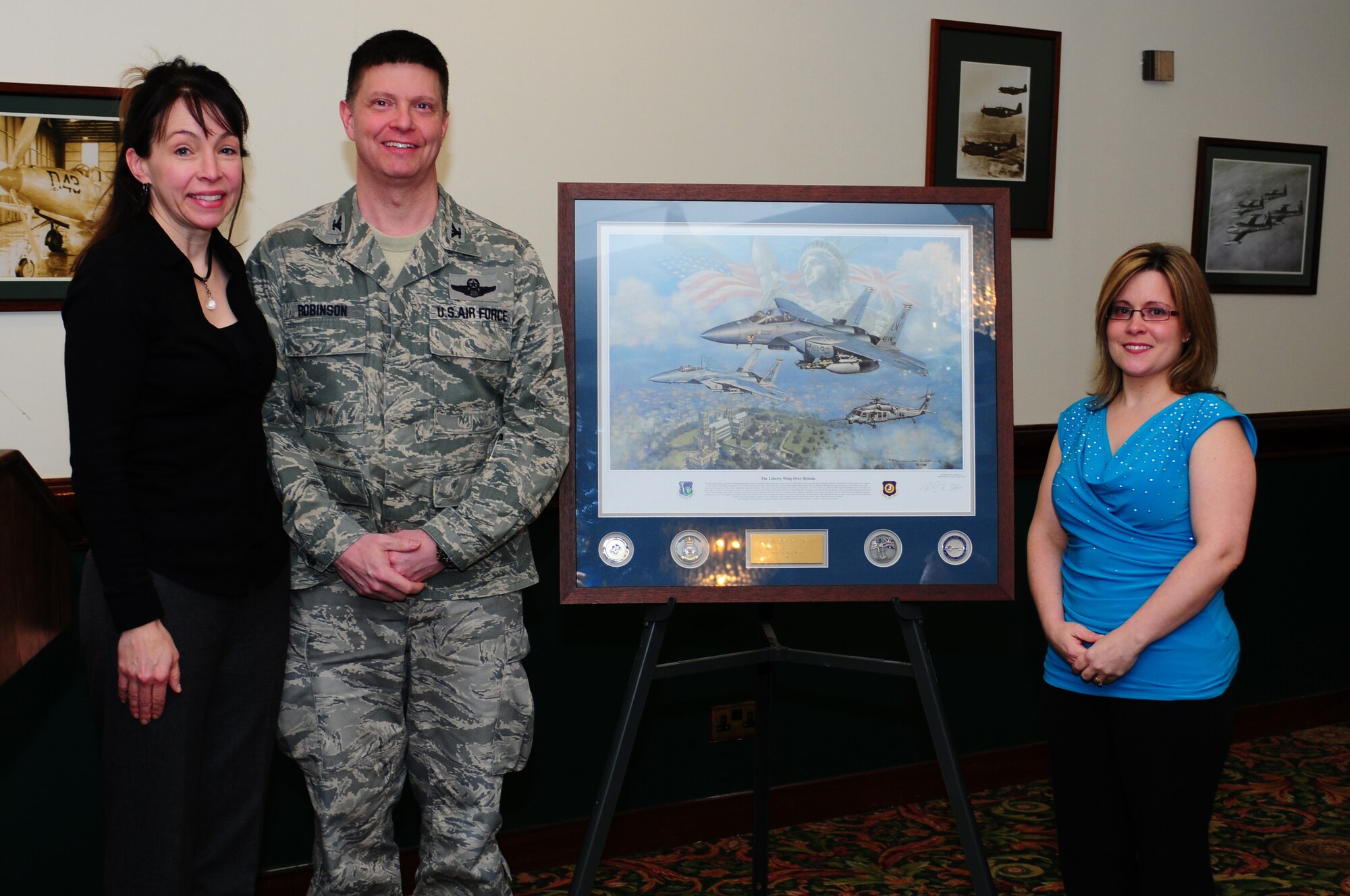ROYAL AIR FORCE LAKENHEATH, England -- Col. Kyle Robinson, 48th Fighter Wing commander, and his wife Maureen, present Holly Blankenship, wife of Master Sgt. Dana Blankenship, 48th Civil Engineer Squadron, with the Key Spouse of the Year award at Eagle's Landing Feb. 1, 2013. Blankenship received the award for her outstanding contributions to the families of military members at RAF Lakenheath. (U.S. Air Force photo by Airman 1st Class Dana J. Butler)