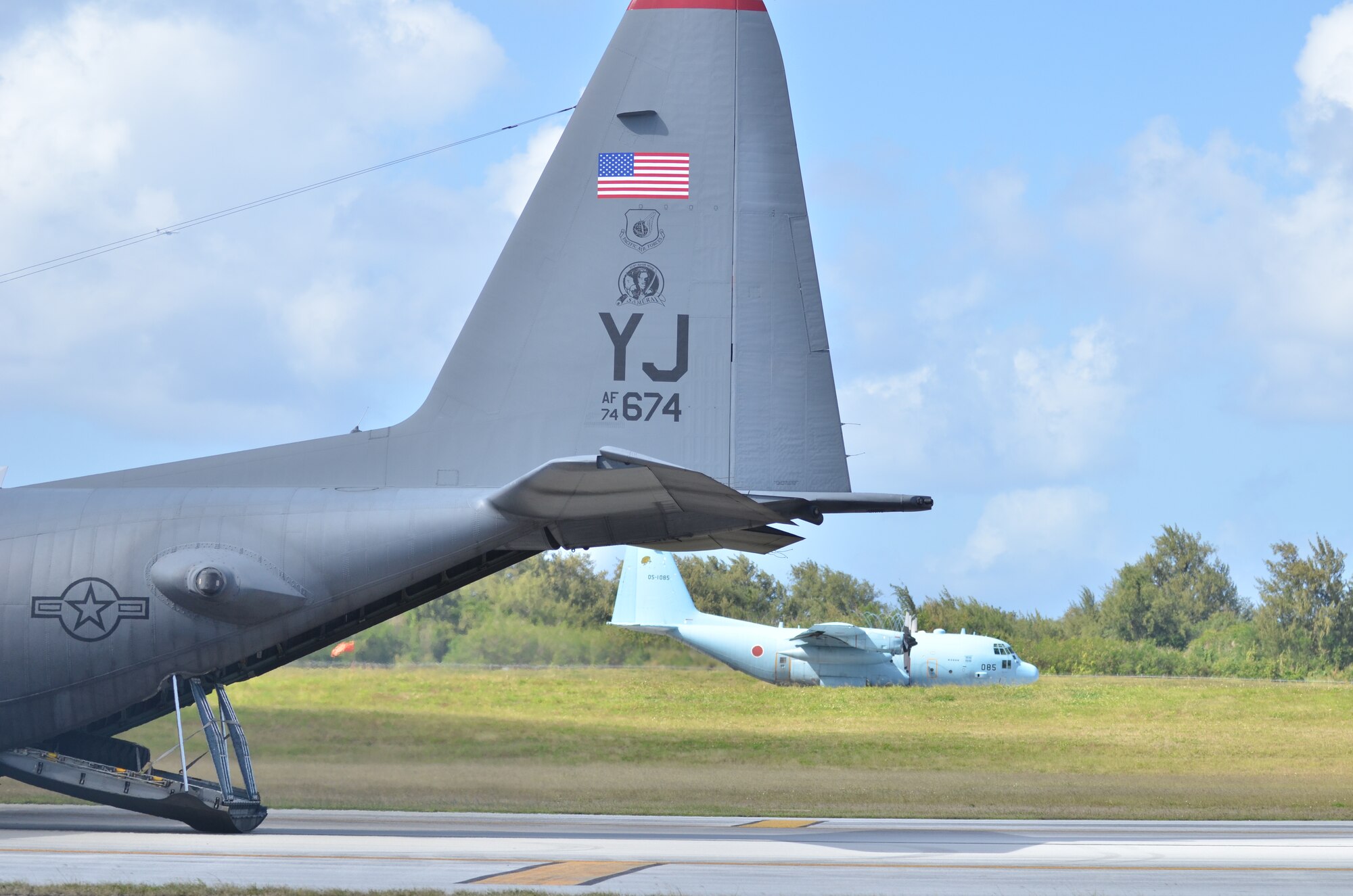 U.S. Air Force and Japan Air Self Defense Aircraft occupy the Tinian Airfield for cargo unloading in support of exercise Cope North 2013 Feb. 5, 2013. Cope North is a multilateral aerial exercise, held once or twice yearly, designed to increase the combat readiness and interoperability of the U.S. Air Force, Japan Air Self-Defense Force, Royal Australian Air Force and other Pacific partner nations. (U.S. Air Force photo by Staff Sgt. Alex Montes/RELEASED)
