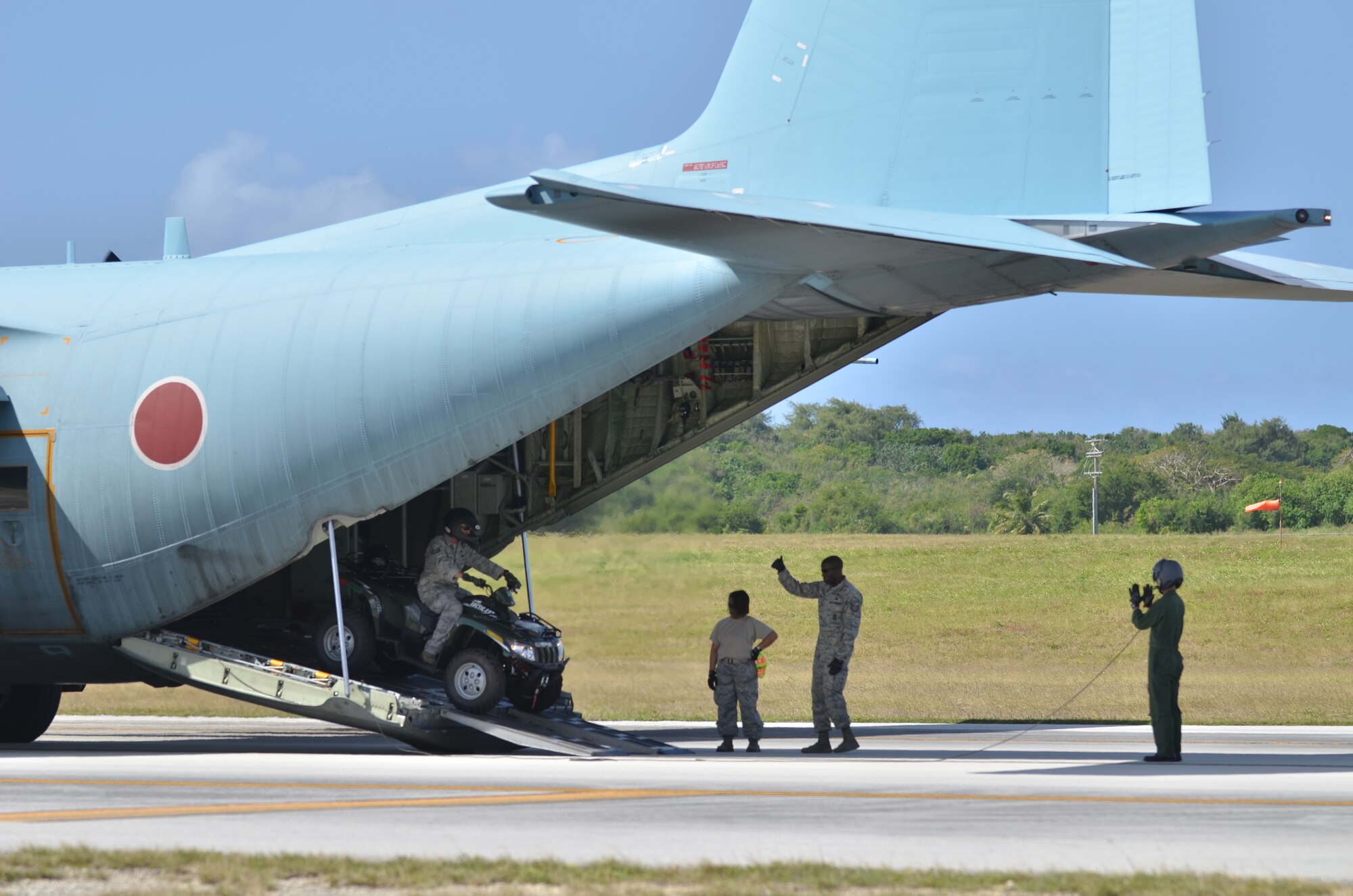 U.S. Air Force Airmen from the 36th Mobility Response Squadron and members of the Japan Air Self Defense Force unload a forklift out the back of a Japanese C-130 on the Tinian Airfield during exercise Cope North 2013 Feb. 5, 2013. Cope North is a multilateral aerial exercise, held once or twice yearly, designed to increase the combat readiness and interoperability of the U.S. Air Force, Japan Air Self-Defense Force, Royal Australian Air Force and other Pacific partner nations. (U.S. Air Force photo by Staff Sgt. Alex Montes/RELEASED)