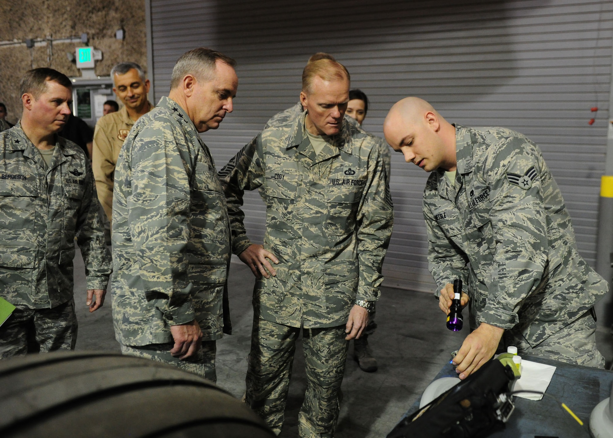 SOUTHWEST ASIA -- Senior Airman Paul Nessle, a non-destructive inspector from the 379th Expeditionary Maintenance Squadron, explains aircraft tire inspection procedures to Air Force Chief of Staff Gen. Mark A. Welsh III and Chief Master Sgt. of the Air Force James Cody during a tour of the 379th Air Expeditionary Wing. (U.S. Air Force photo/Master Sgt. Brendan Kavanaugh)