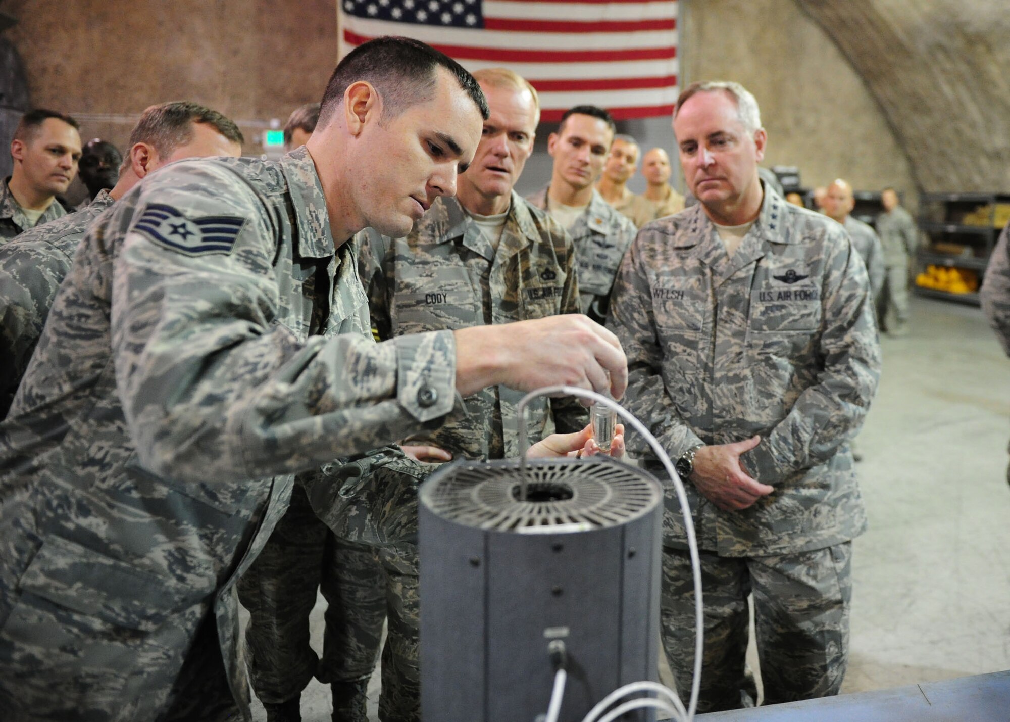 SOUTHWEST ASIA -- Staff Sgt. Joseph Stone, a test, measurement and diagnostic Equipment technician with the 379th Expeditionary Maintenance Squadron, demonstrates equipment used to test precision thermometers to Air Force Chief of Staff Gen. Mark A. Welsh III and Chief Master Sgt. of the Air Force James Cody during a tour of the 379th Air Expeditionary Wing. (U.S. Air Force photo/Master Sgt. Brendan Kavanaugh)