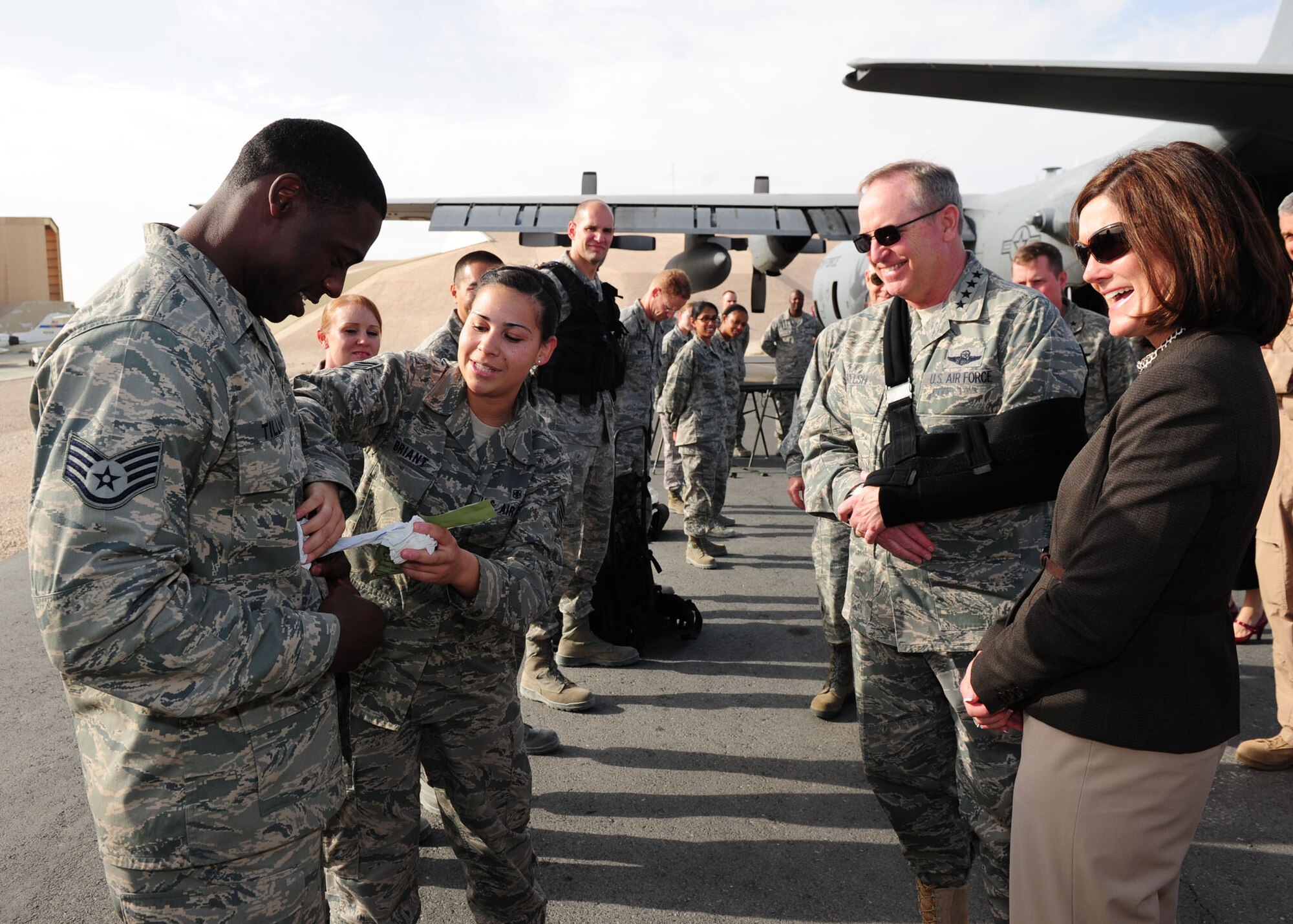 SOUTHWEST ASIA -- Senior Airman Alexia Briant, 379th Expeditionary Medical Group, demonstrates the use of a combat dressing from an Individual First Aid Kit to Air Force Chief of Staff Gen. Mark A. Welsh III and his wife, Betty, during a tour of the 379th Air Expeditionary Wing. The visit was highlighted by a tour of the facilities and talks with the Airmen of the "Grand Slam" Wing about their jobs, deployment and families. (U.S. Air Force photo/Master Sgt. Brendan Kavanaugh)