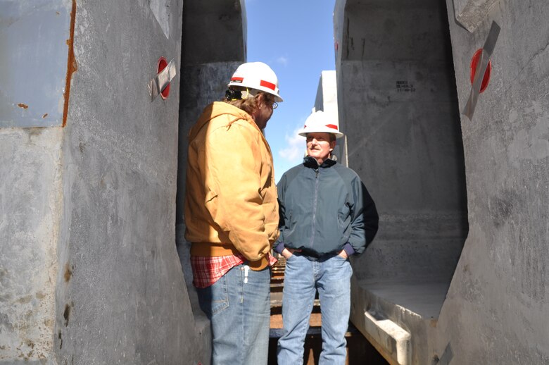 Jamie G. James, U.S. Army Corps of Engineers Nashville District project manager for the Chickamauga Lock Replacement Project, receives a progress update Jan. 31, 2013 from project engineer Jason L. Foust on assembling 300-ton lock approach wall beams at Watt Bar Dam, Decatur, Tenn. The beams are being assembled and stored at Watts Bar for placement in the Chickamauga Lock Replacement Project when required for construction. (USACE photo by Fred Tucker)