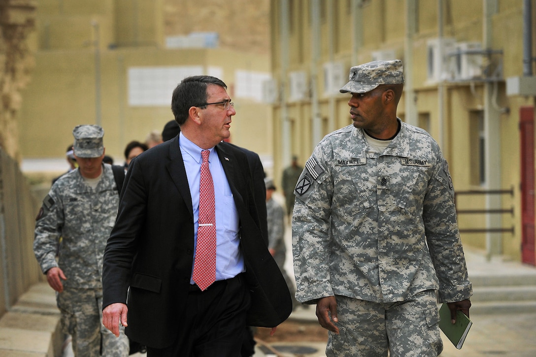 U.S. Army Sgt. Maj. Reginald Maxwell escorts U.S. Deputy Defense Secretary Ashton B. Carter to a troop event near Amman, Jordan, Feb. 5, 2013. Maxwell is assigned to U.S. Army Central Command. 