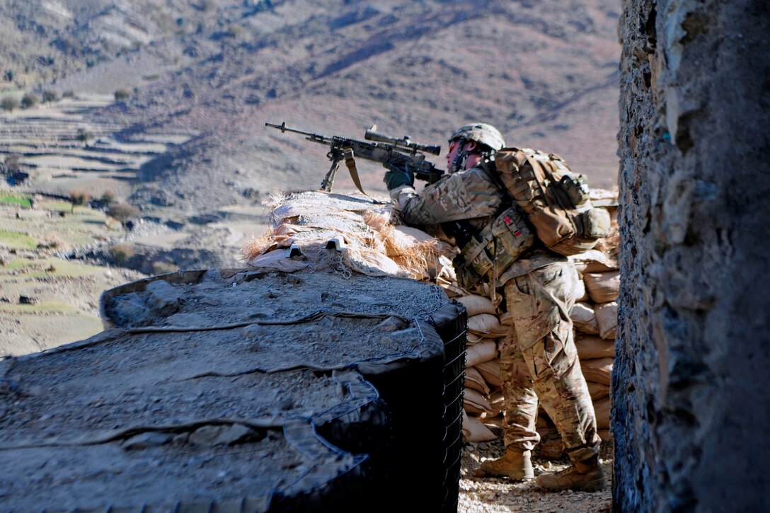 U.S. Army Sgt. Andrew Barnett scans the area using the optic lens on his M14 enhanced battle rifle outside an Afghan border police observation point in Kunar province, Afghanistan, Jan. 28, 2013. Barnett is assigned to the 101st Airborne Division's 2nd Battalion, 327th Infantry Regiment, 1st Brigade Combat Team.