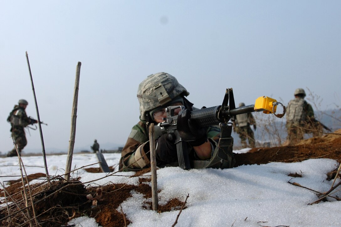 U.S. Army Spc. Michael Ortiz, foreground, provides security for fellow soldiers during medical evacuation training in Yeoncheon, South Korea, Jan. 31, 2013. Ortiz, a multiple launch rocket system repairer specialist, is assigned to the 2nd Infantry Division's Headquarters Battery, 6th Battalion, 37th Field Artillery Regiment, 210th Fires Brigade. 
